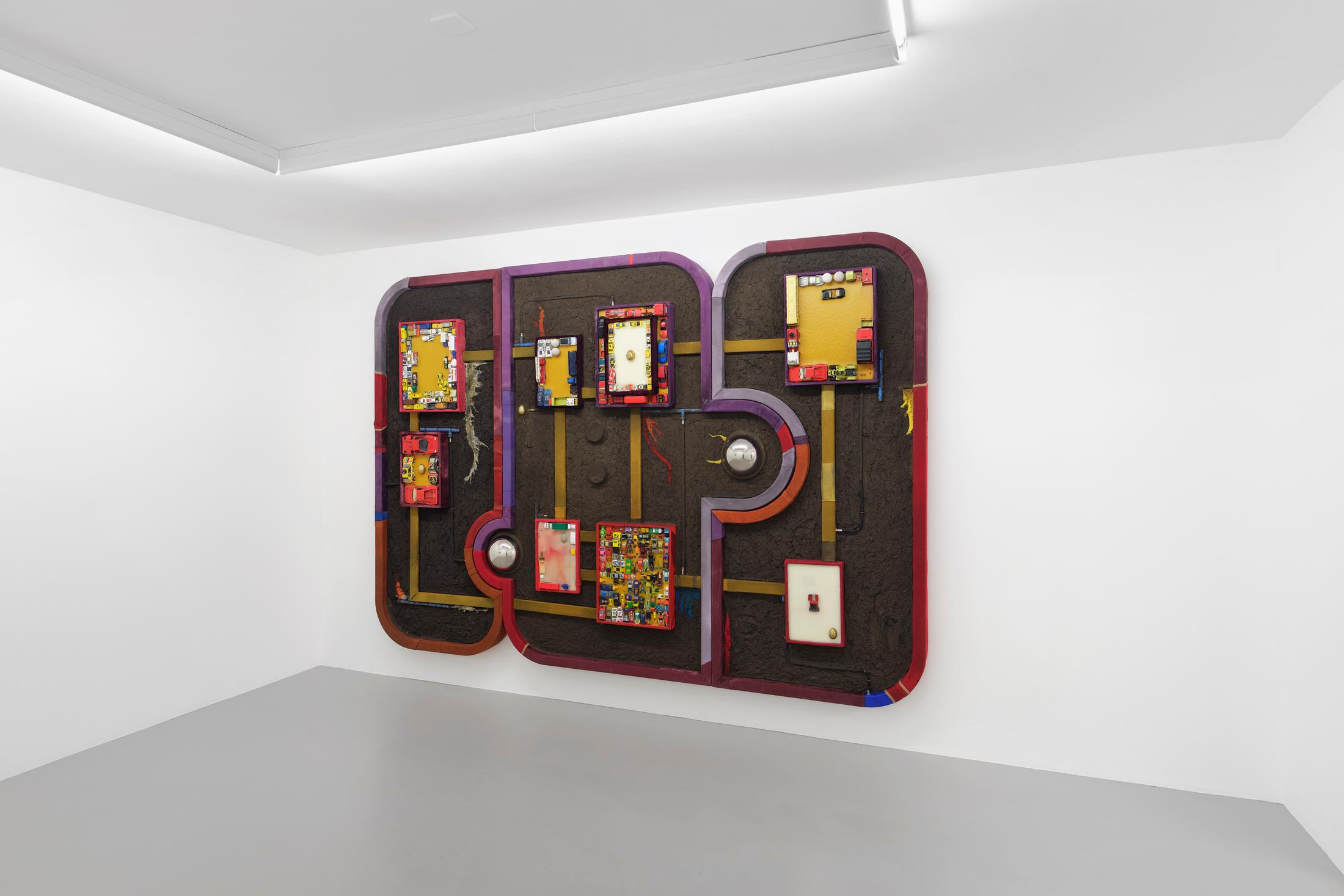 Exhibition View Pedro Wirz Solo Show «Tooth of a Giant; view on Pedro Wirz, Soil’s Memory, 2020, Beeswax, textile debris, concrete cast, bronze cast, plaster cast, iron cast, toys, acrylic on wood, 200 x 355 x 17 cm» at GALERIE PHILIPPZOLLINGER, Zurich, 2020 / Photo: Conradin Frei / Courtesy: the artist and GALERIE PHILIPPZOLLINGER