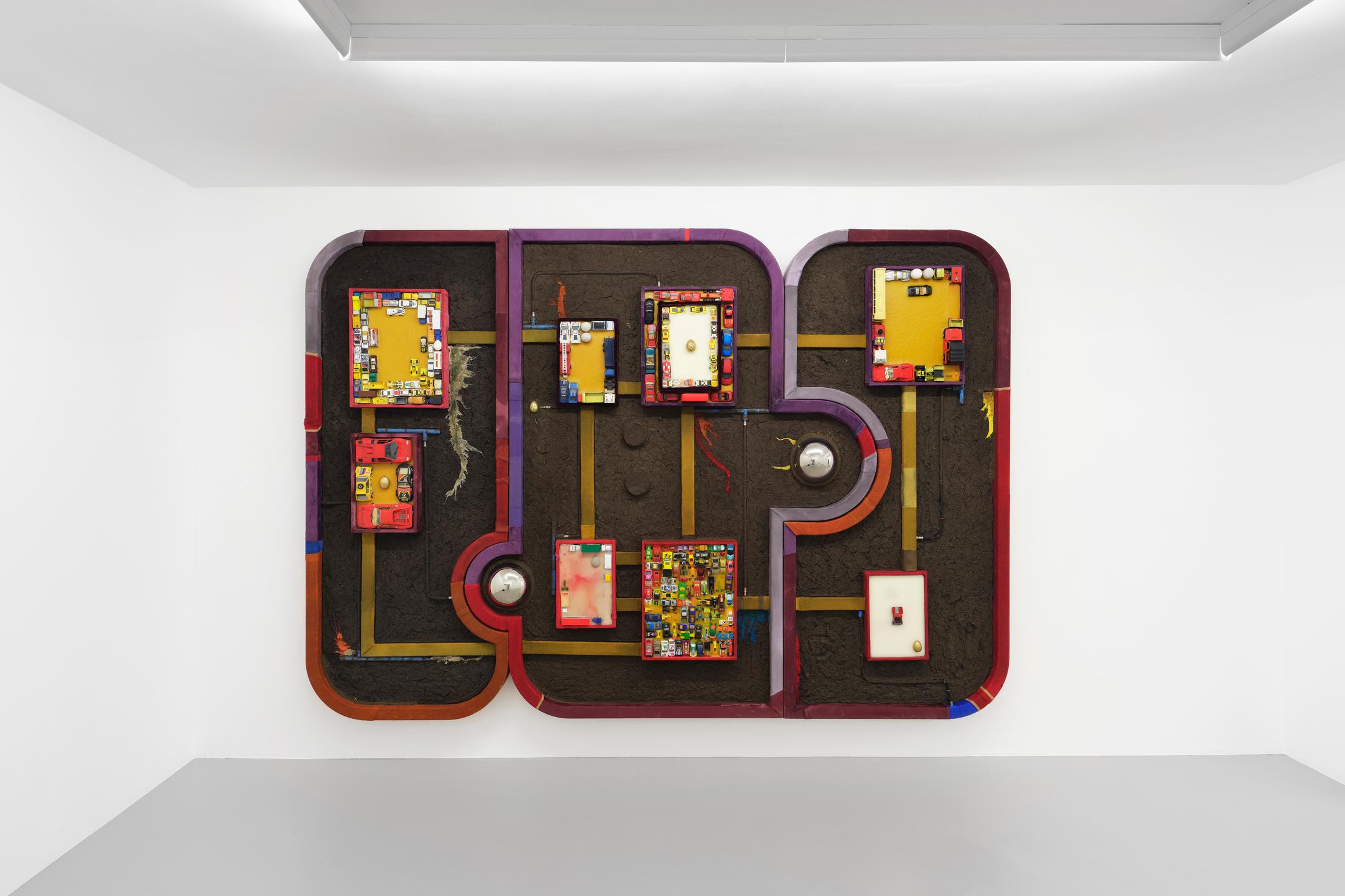 Exhibition View Pedro Wirz Solo Show «Tooth of a Giant; view on Pedro Wirz, Soil’s Memory, 2020, Beeswax, textile debris, concrete cast, bronze cast, plaster cast, iron cast, toys, acrylic on wood, 200 x 355 x 17 cm» at GALERIE PHILIPPZOLLINGER, Zurich, 2020 / Photo: Conradin Frei / Courtesy: the artist and GALERIE PHILIPPZOLLINGER