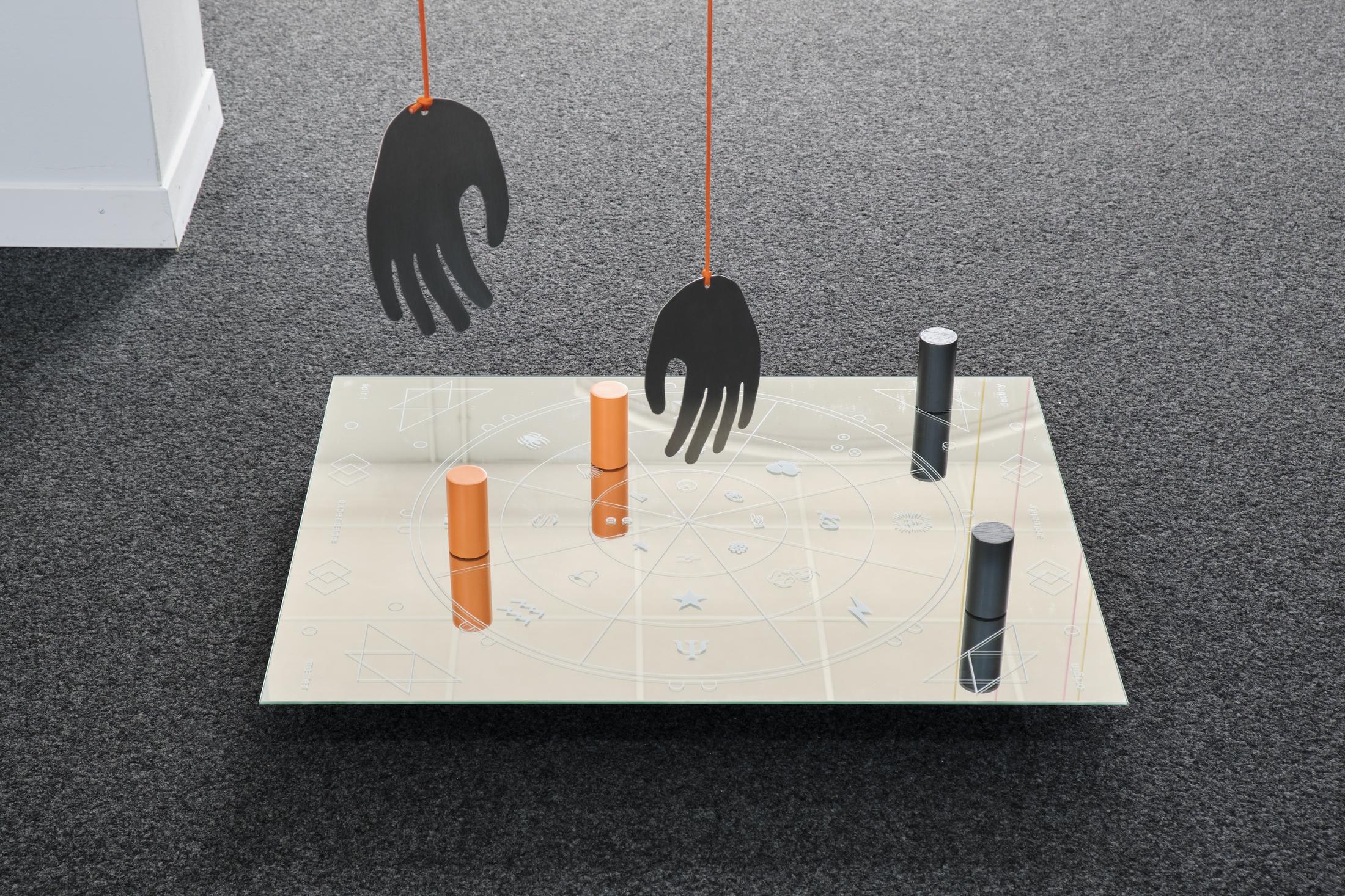 Exhibition View Philip Ullrich Solo Show «Remmidemmi in der Spielhölle (The Game Show); view on Philip Ullrich, at play (spiritual connection), 2023, screen print on mirror, painted wood, metal, paracord mirror: 77 x 61 x 0.4 cm, with hands: dimensions variable» at unanimous consent, Zurich, 2023 / Photo: Philip Ullrich / Courtesy: the artist and unanimous consent