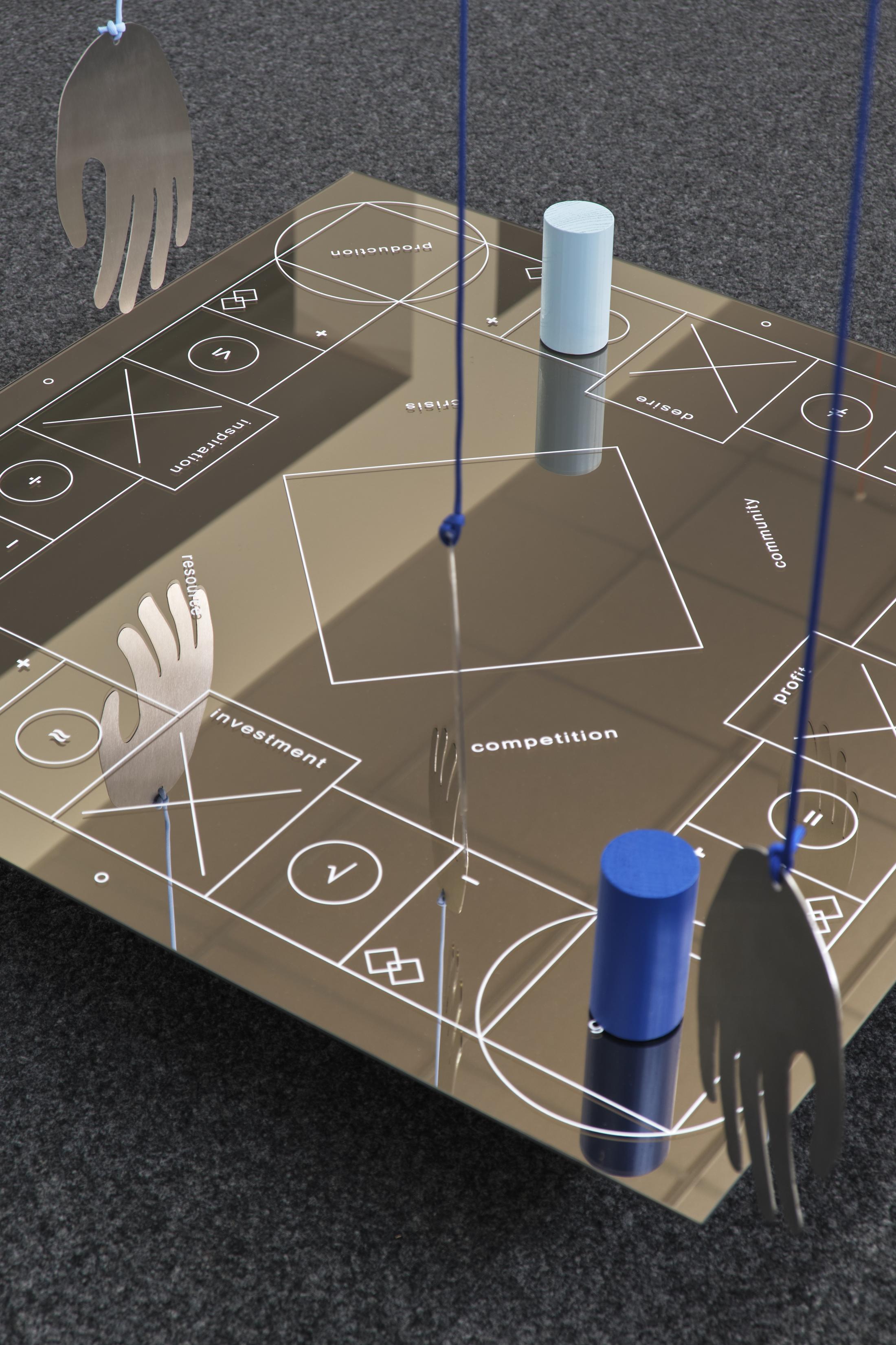 Exhibition View Philip Ullrich Solo Show «Remmidemmi in der Spielhölle (The Game Show); view on Philip Ullrich, at play (off the charts), 2023, screen print on mirror, painted wood, metal, paracord mirror: 75 x 75 x 0.4 cm, with hands: dimensions variable» at unanimous consent, Zurich, 2023 / Photo: Philip Ullrich / Courtesy: the artist and unanimous consent