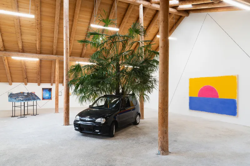 Exhibition View Group Show «This Morning, in the Sweet Torpor of the Great Forest, is Like Every Morning in the World; view on Violeta Burckhardt, Wir Schaffen Das, 2020, Fiat car, earth, Trachycarpus fortunei (palm trees from Ticino, Switzerland), Dimensions variable» at Country SALTS, Bennwil, 2020 / Photo: Gunnar Meier / Courtesy: the artist