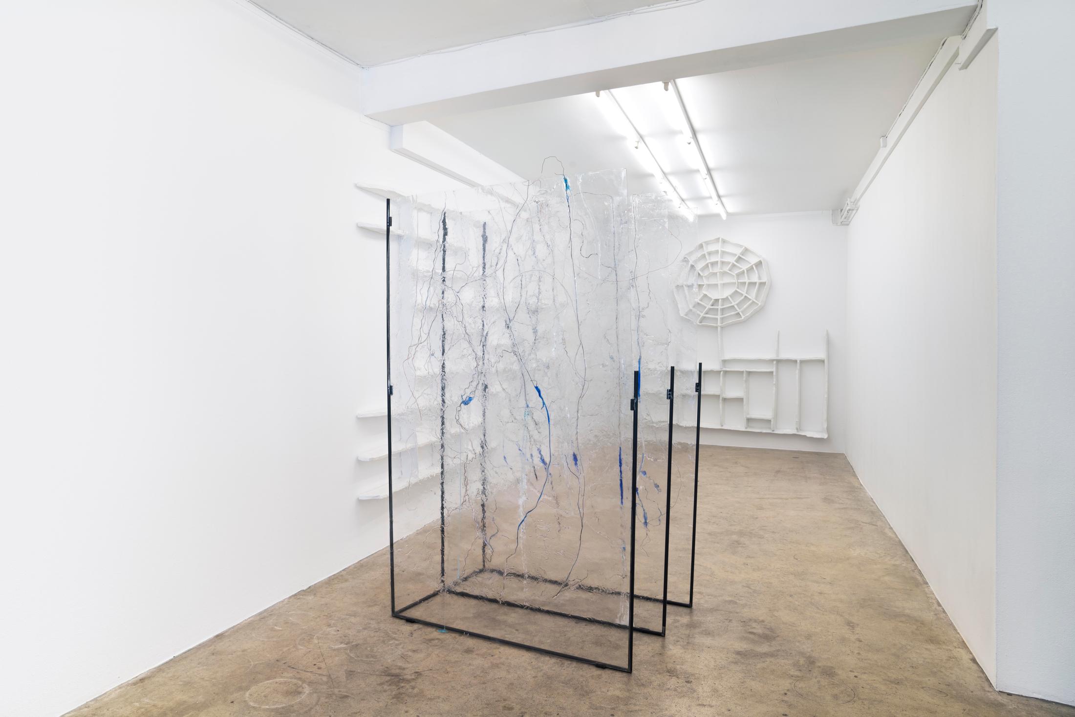 Exhibition View Groupshow «Winds of Change; view on Matheline Marmy, Conteneur (parasite), 2020, (front), 205x 80x 125 cm, water, ammonia, sodium chloride, copper wires, extruded co-polyester, steel; Vinzenz Meyner, Family Business, 2020, (back left) 185 x 480 cm, Papier mâché and Vinzenz Meyner, Soft Skills, 2020, (back right) 235 x 250 cm, Papier mâché» at Milieu, Bern, 2020 / Courtesy: the artist and Milieu, Bern