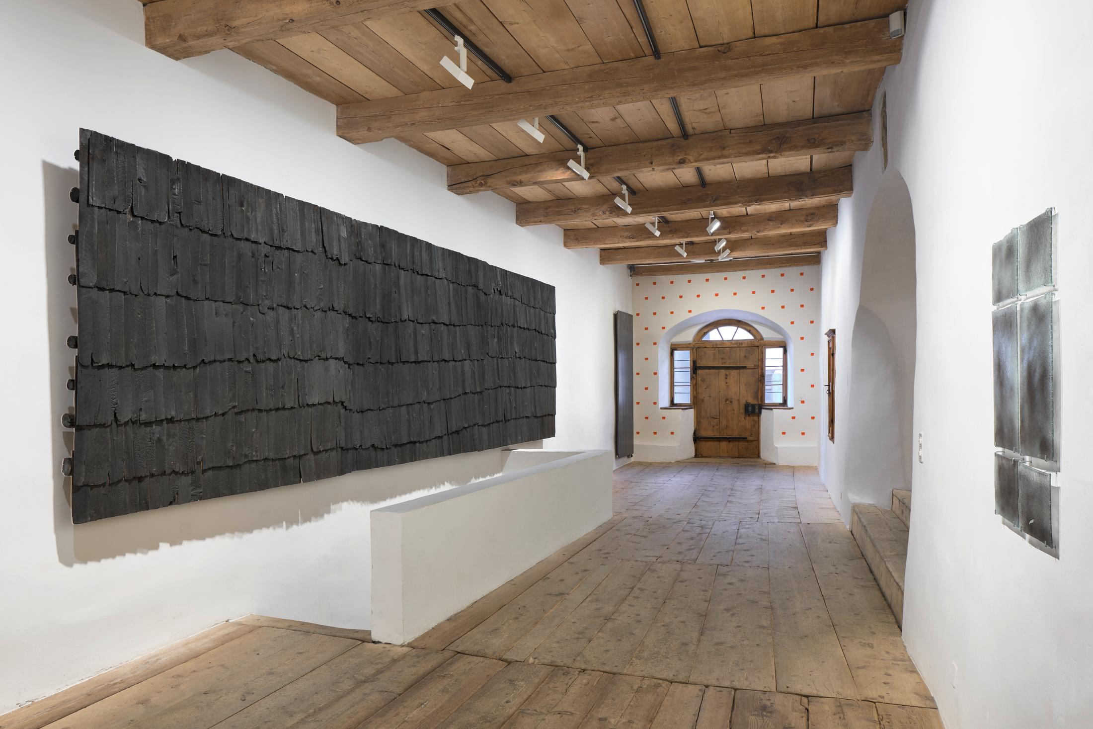 Exhibition View Augustas Serapinas Solo Show «Wood and Snow; view on Augustas Serapinas, Remains of the House from Skirgiškės, 2022, Reclaimed Wood, 370 x 480 x 500 cm» at Galerie Tschudi, Zuoz, 2022-2023 / Photo: Raphael Feiner / Courtesy: the artist and Galerie Tschudi