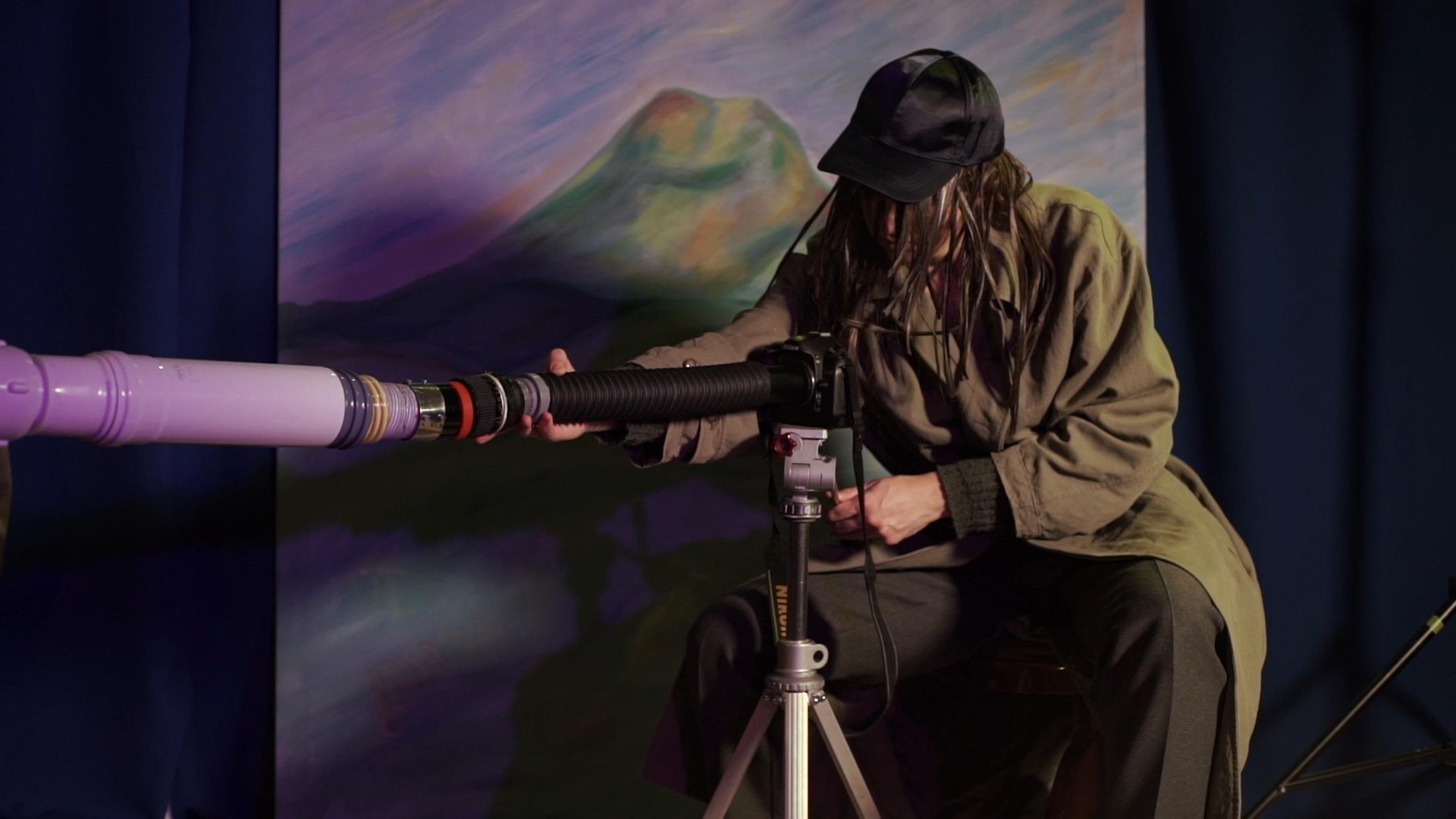 Exhibition View Beatrice Marchi and Mia Sanchez Duo Show «La Città e i Perdigiorno; view on Beatrice Marchi, The Photographer & The Friends (Nel Mondo Parallelo), 2021. Film still. HD digital video, sound, 15’38’’» at Istituto Svizzero, Milan, 2021 / Photo: Giulio Boem / Courtesy: artist and SANDY BROWN Berlin