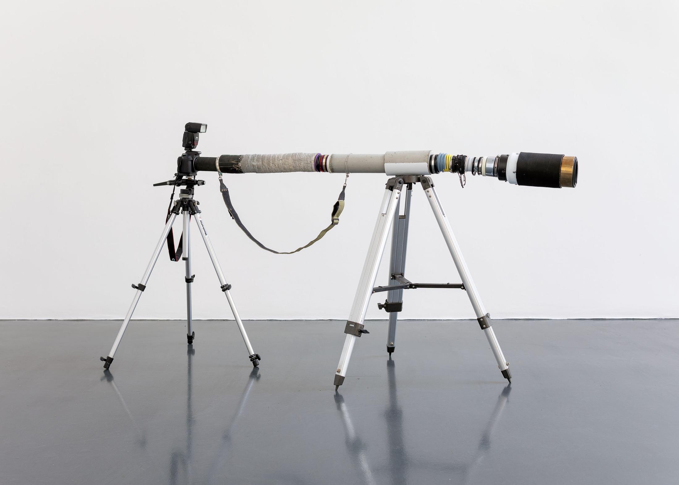 Exhibition View Beatrice Marchi and Mia Sanchez Duo Show «La Città e i Perdigiorno; view on Beatrice Marchi, The Photographer Lens, 2021, camera, concrete, glass, rubber, steel, pvc, aluminum, tripods, 190 x 130 x 100 cm» at Istituto Svizzero, Milan, 2021 / Photo: Giulio Boem / Courtesy: artist and SANDY BROWN Berlin