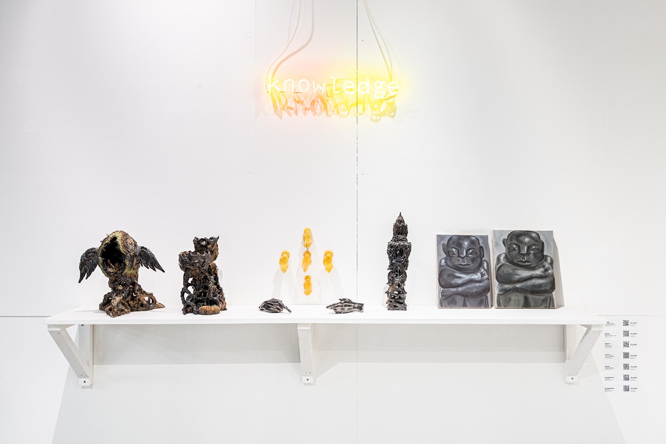 Exhibition View Group Show «Collections d’Artistes; view on Anja Ripoll, Humble Defector’s Egg, 2024, stoneware, porcelain, fabrics, glaze, metal, vegetations, 36 x 32 x 25 cm; Anja Ripoll, Sylvan scrying, 2022, stoneware, fabrics, glaze, platine, 22 x 36 cm; Aramis Navarro, k(now)ledge, 2022, neon, 70 x 15 x 4 cm; Jeanne Tara, Coulant, 2022, beeswax, 10 x 10 x 10 cm; Jeanne Tara, La force des choses, 2024, glazed ceramic, 20 x 15 x 10 cm; Anja Ripoll, Quagmire Lamprey, 2024, stoneware, fabrics, glaze, 12 x 28 cm; Yann Stéphane Bisso, Sans Titre, 2024, oil on canvas, 33 x 24 cm; Yann Stéphane Bisso, Sans Titre, 2024, oil on canvas, 27.5 x 35 cm» at Le Commun, Geneva, 2025 / Photo: Daniel Leal / Courtesy: Spielact Festival