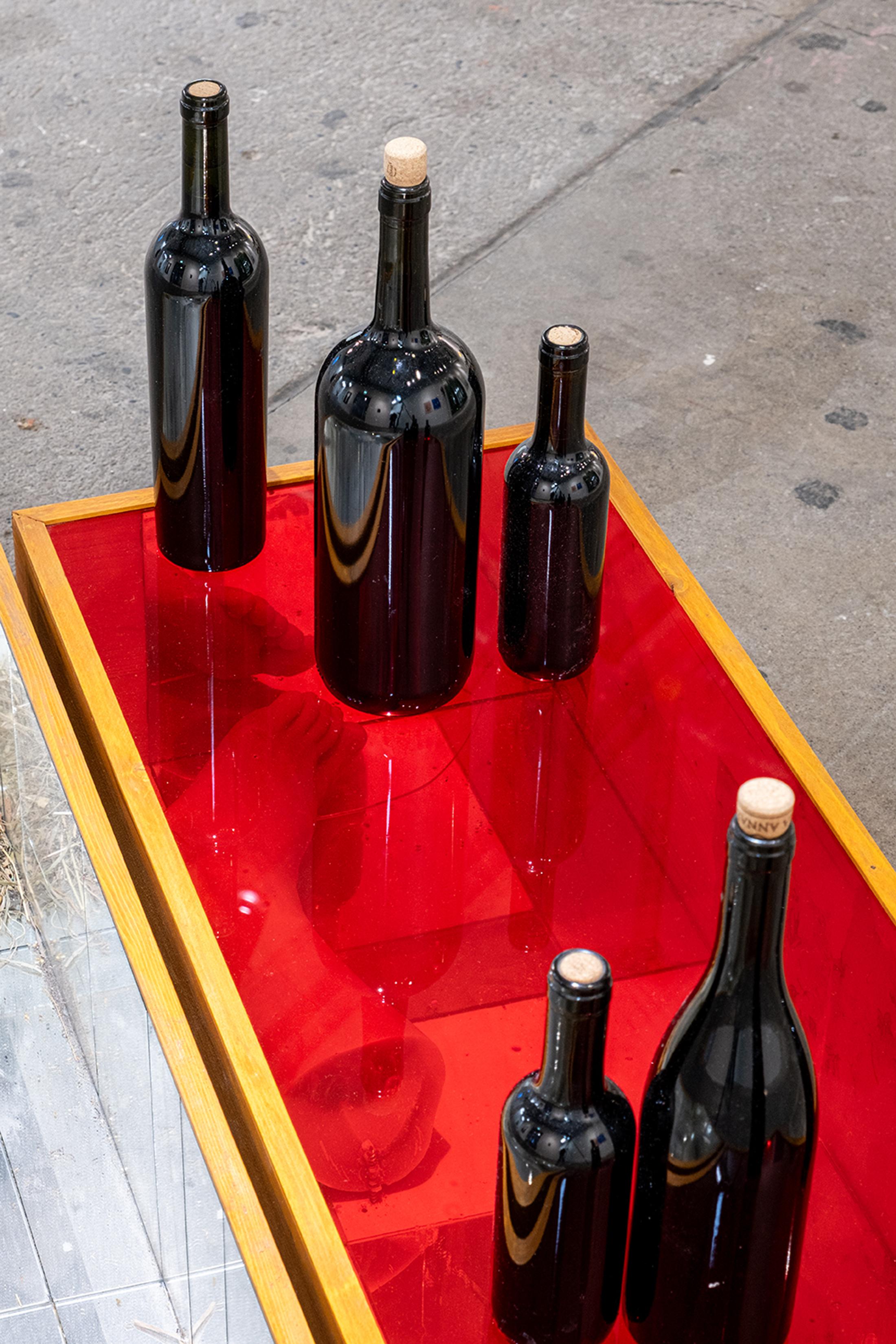 Exhibition View Group Show «Collections d’Artistes; view on Paulo Wirz, Heranças, 2022, wood, hand-painted glass, mirrors, wax casts, wine bottles, 110 x 30 x 30 cm» at Le Commun, Geneva, 2025 / Photo: Daniel Leal / Courtesy: Spielact Festival