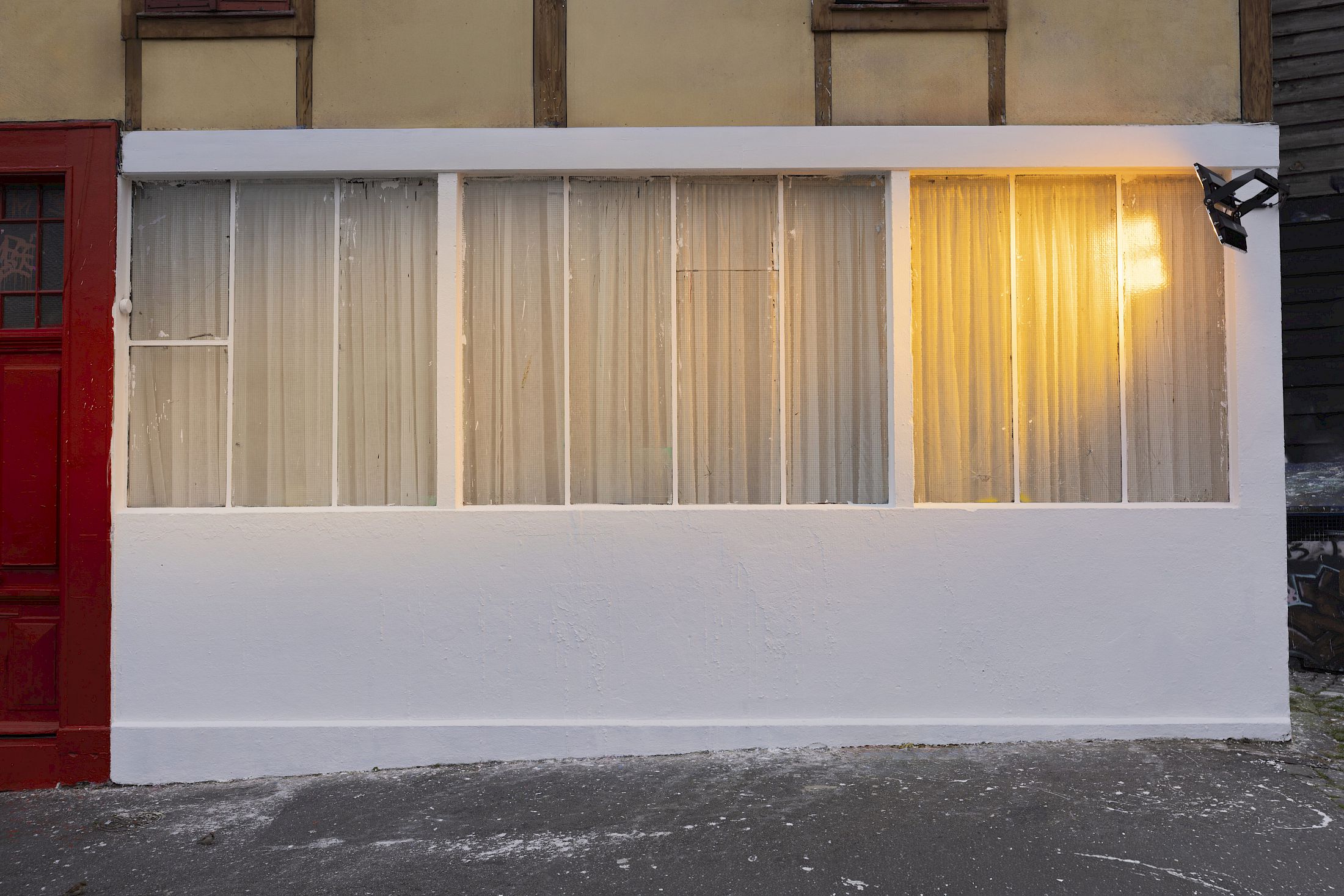 Exhibition View Solo Show Clément Grimm «Video 50 ; view on Ecclesiastes 1:14, 2025, Curtain, steel cable, LED light, gel filter, steel structure, Dimensions variable to space, Serie of 3 protocols - Edition 1/3» at Kissed Then Burned, Geneva, 2025-2026 / Photo: Antoni Aeby / Courtesy: the artist and Kissed Then Burned