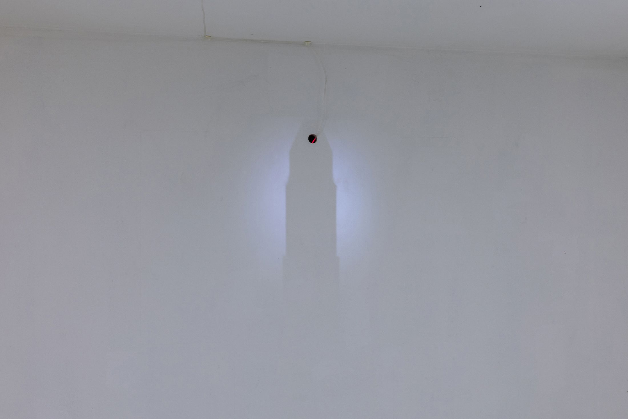 Exhibition View Solo Show Hunter Longe «Entgleitungen ; view on Degradation Pathway, 2025, (detail), laser distance sensor, mounting system, projector, video loop, lenses, dimensions variable» at City SALTS, Baselland, 2025-2026 / Photo: Nicolas Gysin / Courtesy: the artist and City SALTS