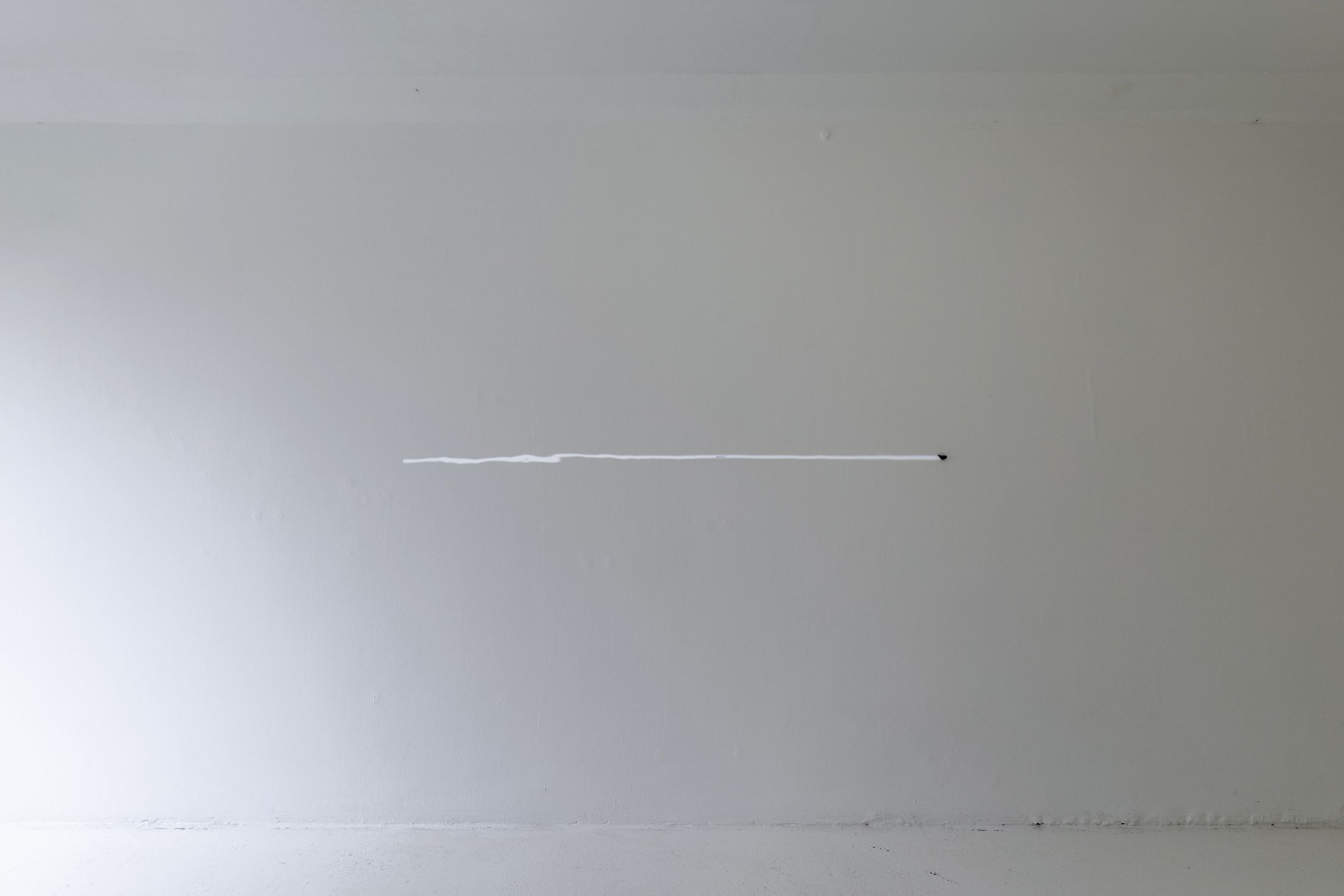 Exhibition View Solo Show Hunter Longe «Entgleitungen ; view on the past inserts a finger into a slit on the skin of the present and pulls 4, 2025, meteorite fragment (~5000 years old, Argentina), LSD blotter tabs, projector, video loop, Dimensions variable» at City SALTS, Baselland, 2025-2026 / Photo: Nicolas Gysin / Courtesy: the artist and City SALTS