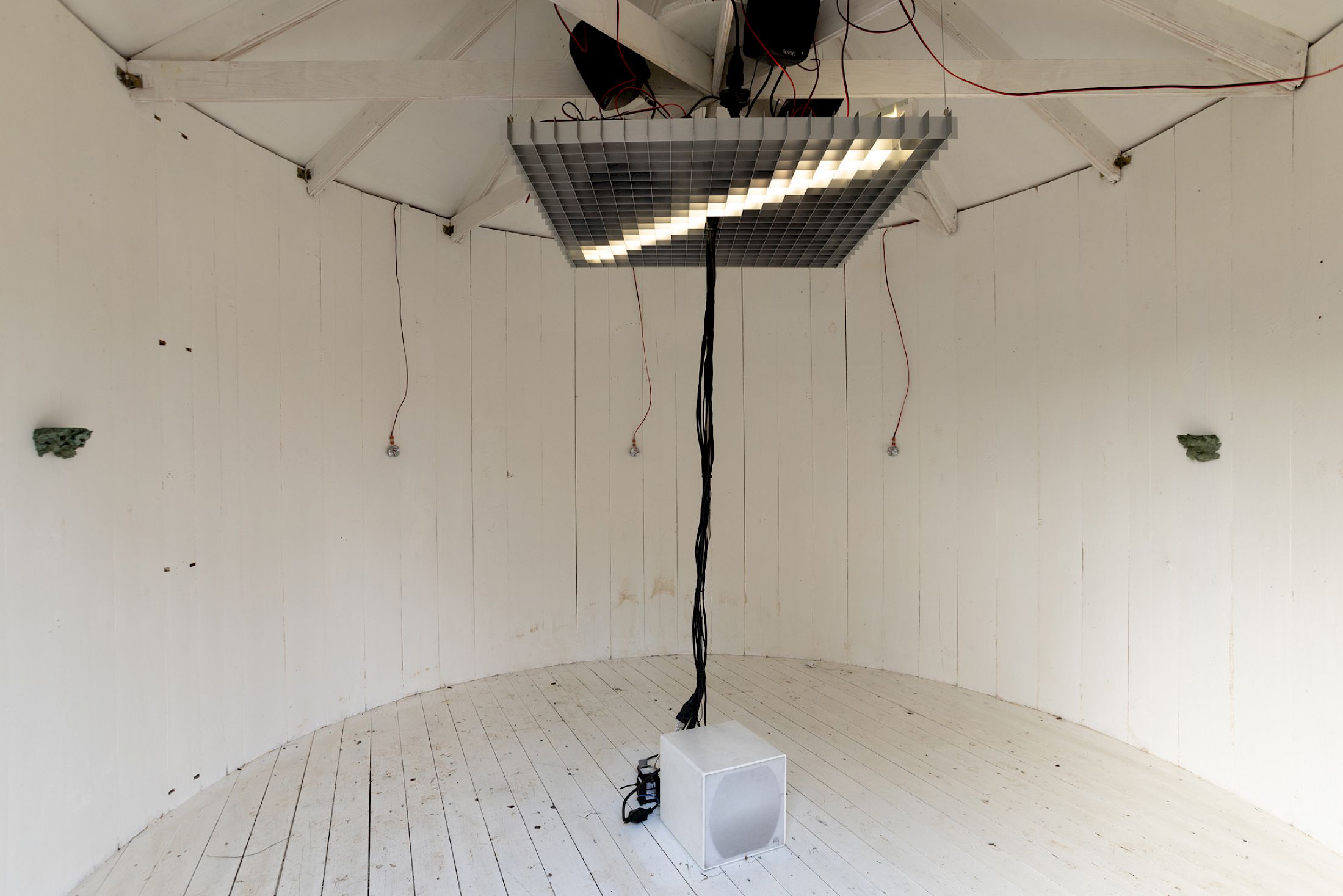 Exhibition View Solo Show Hunter Longe «Entgleitungen ; view on Hunter Longe in collaboration with Janiv Oron, High Static, Dead Lines, 2025, 8.1 channel sound installation - electric rely, coil, timer, contact mics, transducers, sub, mixer, media players, audio, starter, fluorescent lights, dimensions variable» at City SALTS, Baselland, 2025-2026 / Photo: Nicolas Gysin / Courtesy: the artist and City SALTS