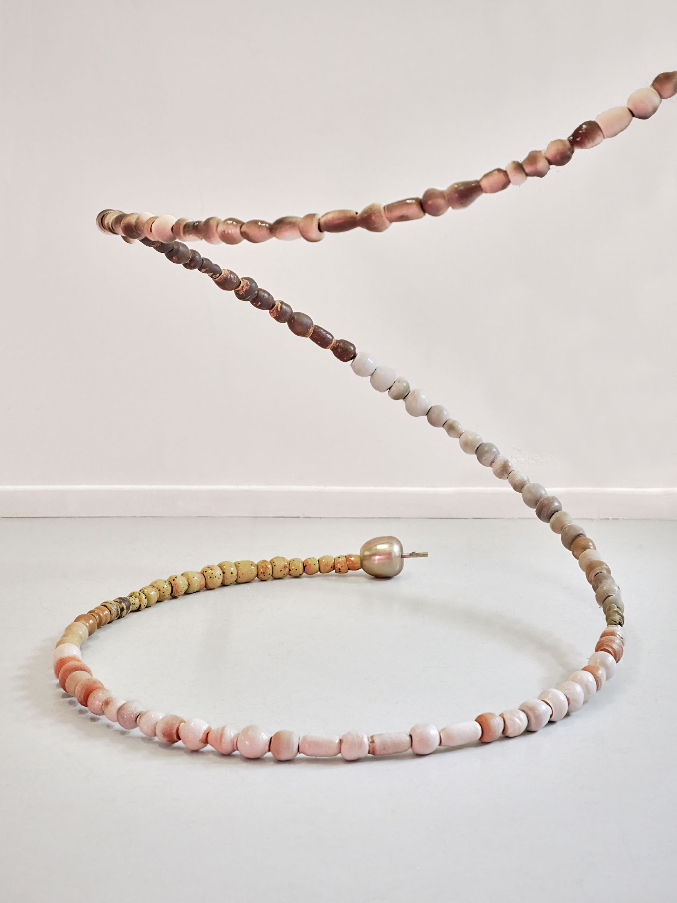 Exibition View Solo Show Camille Dumond «Everything but sliced ; view on Bullet time, 2025, Suspension, steel, earthenware, stoneware, 4.5 m» at Ferme de la Chapelle, Geneva, Grand-Lancy, 2025 / Photo: Nicolas Delaroche / Courtesy: the artist and Ferme de la Chapelle