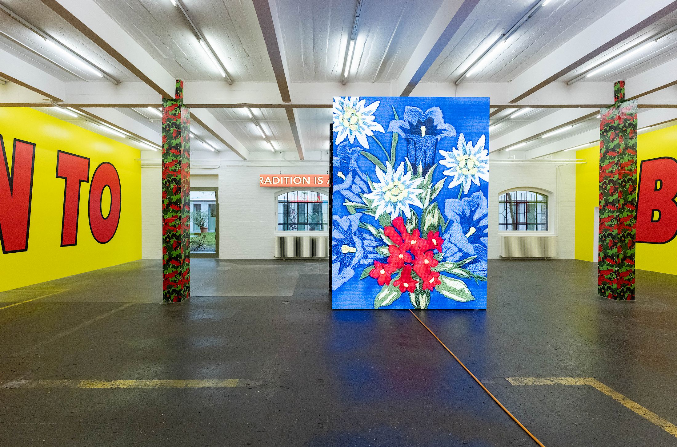 Exhibition View Solo Show Cemile Sahin «BB – BORN TO BLOOM ; view on BB – BORN TO BLOOM, 2025, 4-channel video installation on LED screens with sound, 5min 10s, wallpaper» at Kunst Halle Sankt Gallen, Sankt Gallen, 2025 / Photo: E. Sommer / Courtesy: the artist and Esther Schipper, Berlin/Paris/Seoul