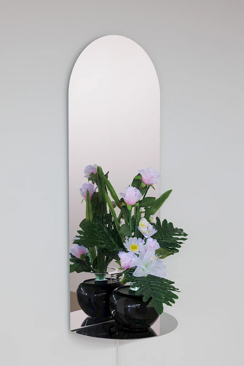 Exhibition View Dorota Gawęda & Eglė Kulbokaitė Solo Show «Death by Landscape; view on Dorota Gawęda & Eglė Kulbokaitė, Votive Flowers II, 2022, lightbulb, optical fibres, paper and plastic flowers, electric cable, colour gel disc and rotating mechanism, mirror polished stainless steel. 68 x 36 x 18 cm» at Haus für Kunst Uri, Altdorf, 2025 / Photo: Franz-Xaver Brun / Courtesy: the artists and Haus für Kunst Uri