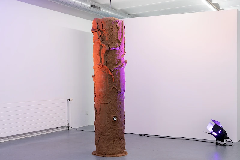 Exhibition View Group Show «Ecstatic Trance: Artists on Rock My Religion ; view on Ashton Phillips, Authority Complex (Mold me. Hold me. Take me. Break me. Use me for your pleasure. Be not afraid.), 2025, Clay, wire, burlap, steel, wool, stage lights, 4-channel sound work, 195 × 47 cm» at marytwo, Luzern, 2025-2026 / Photo: Jack Pryce / Courtesy: the artist and marytwo