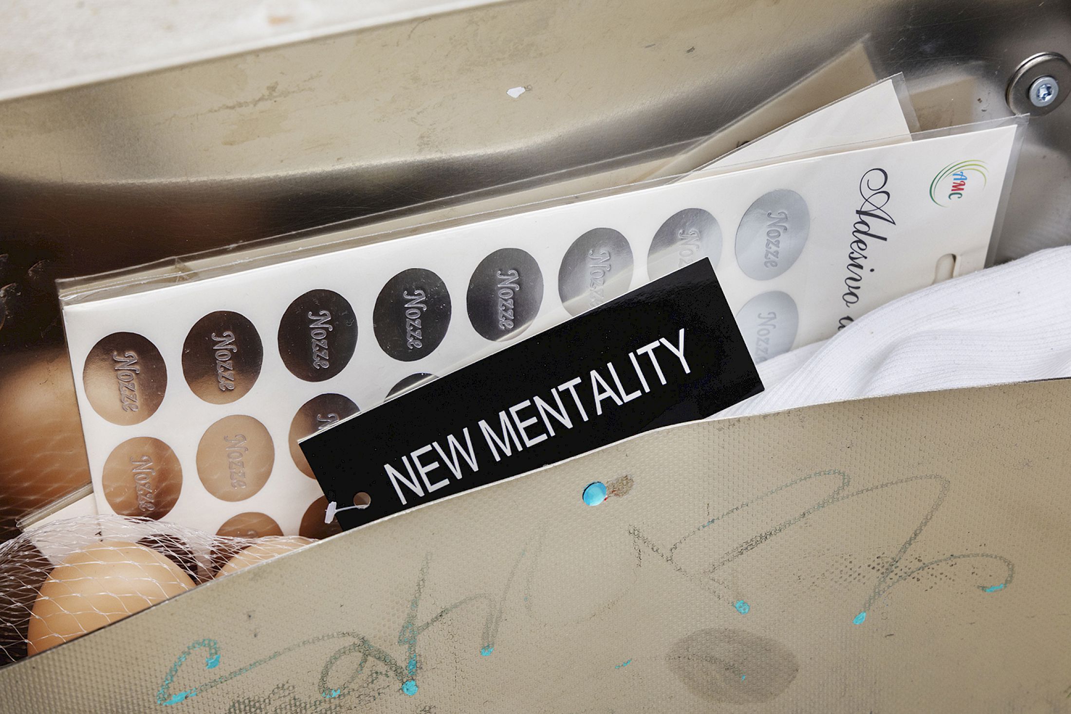 Exhibition View Solo Show Jiajia Zhang «How To Spend It ; view on Cassetta Pubblicità (Amicizia Irl /New Mentality) , 2024, Stickers, top with tag, plastic eggs, ribbon with magnets, found mailbox, 32 × 31 cm, (detail)» at Milieu, Bern, 2025 / Photo: Jiří Makovec / Courtesy: the artist and Milieu