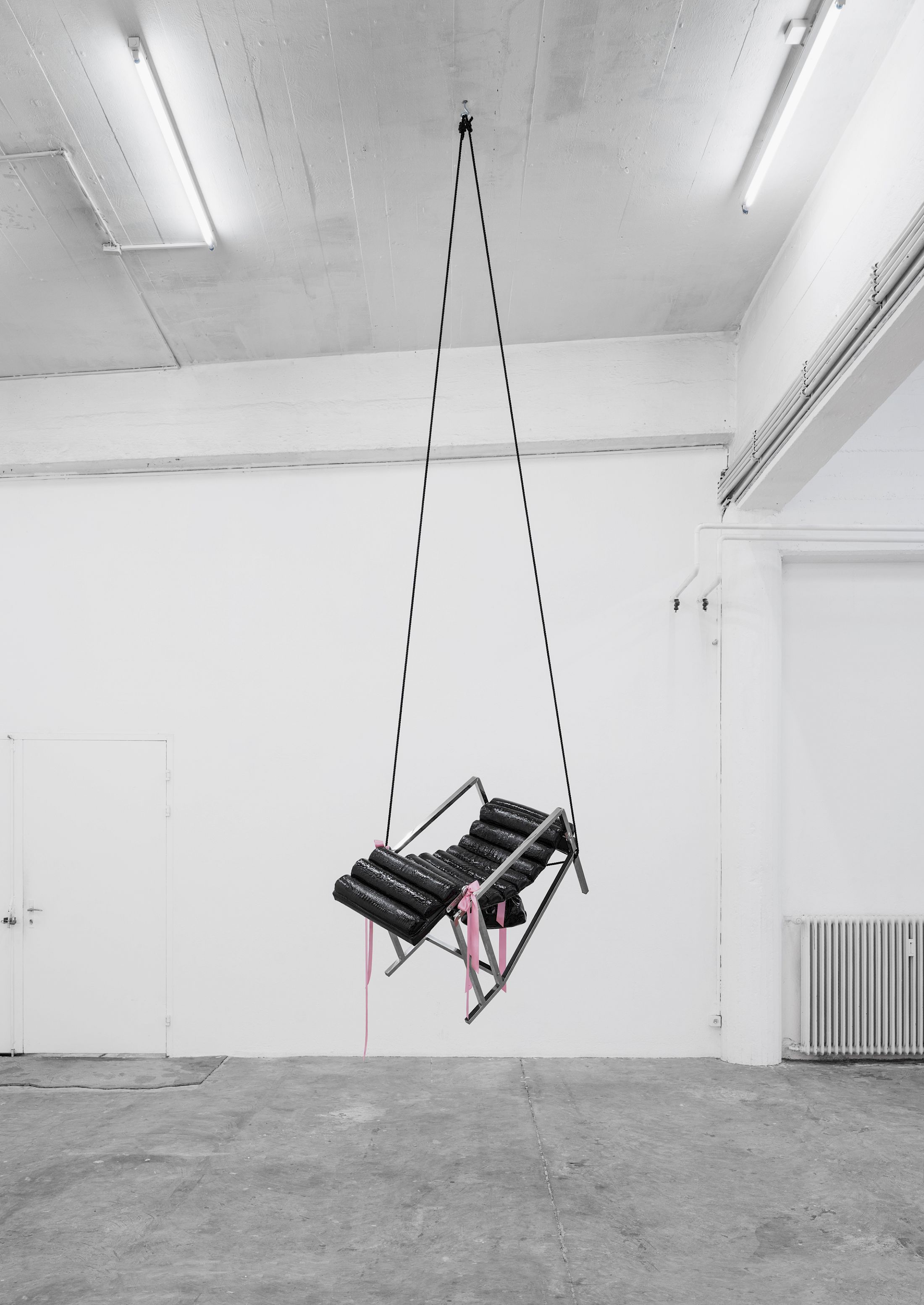 Exhibition View Solo Show Lauryn Youden «I wanna hold the hand inside you ; view on Of the love-moved wind; The exalting secrecies, 2025, Transat Chair (1927) with black faux crocodile skin, rose ribbons, black faux crocodile skin handbag (Claire's), pink pepper spray holder, black Kubotan, pink pom pom keychain, black rape whistle keychain, Eiffel Tower keychain, book: NANA Manga by Ai Yazawa Volume (6), black mooring line, 390 × 55 × 106 cm (suspended)» at CIRCUIT, Lausanne, 2025 / Photo: Aude Mayer / Courtesy: the artist and CIRCUIT