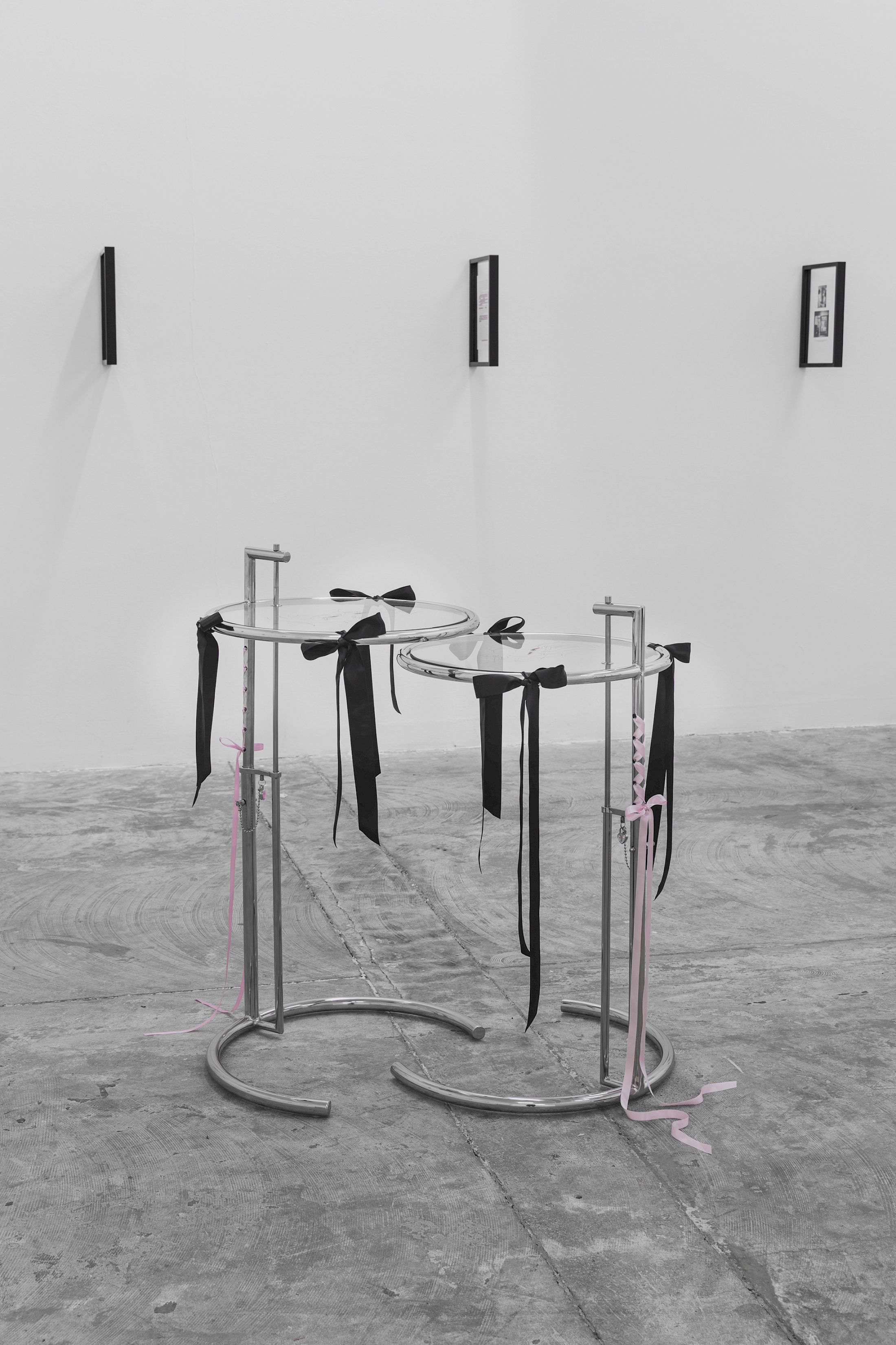 Exhibition View Solo Show Lauryn Youden «I wanna hold the hand inside you ; view on Hey Nana, if you and I were lovers, would we have been able to fill the emptiness by holding each other?, 2025, 2x E-1027 Adjustable Tables (1927), black ribbons, pink ribbons, glass engravings of Utena Revolutionary Girl kiss, red oil paint, 96.5 × 95 × 56 cm» at CIRCUIT, Lausanne, 2025 / Photo: Aude Mayer / Courtesy: the artist and CIRCUIT