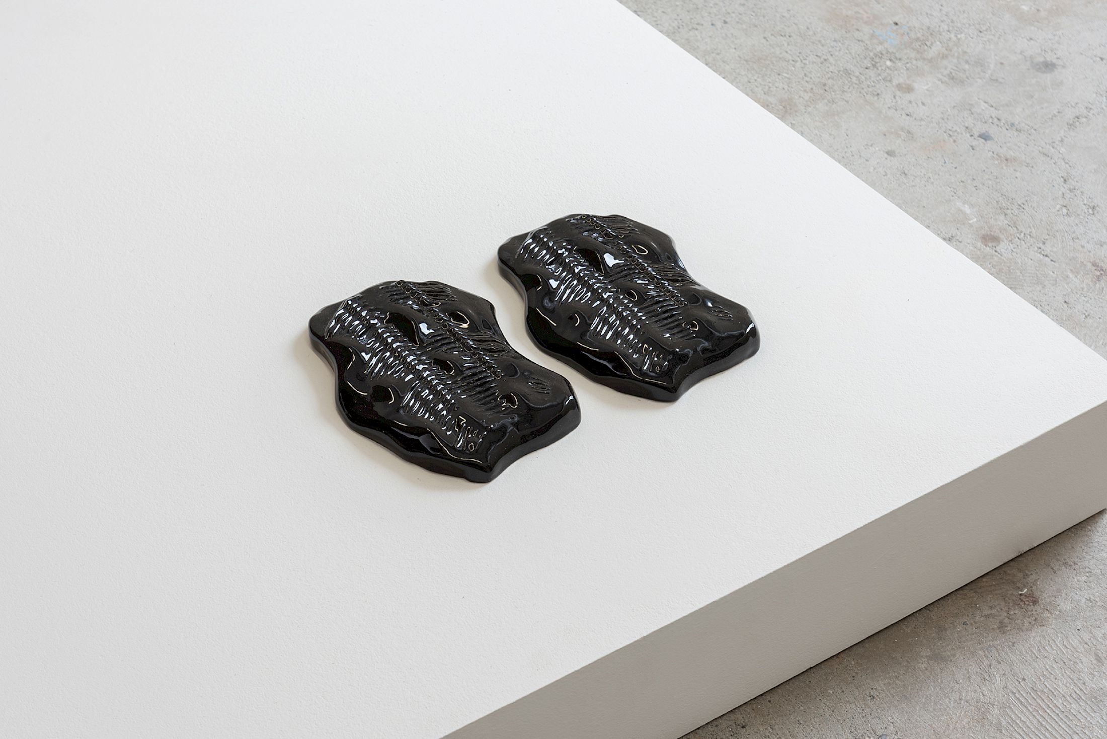 Exhibition View Group Show «Stocker comme des objets ; view on Anita Muçolli, Ghosts of Our Skin, 2025, glazed ceramic, ~25 × 14 × 3 cm, identical piece» at Widefield, Geneva, 2026 / Photo: Remy Ugarte Vallejos / Courtesy: the artists and Widefield