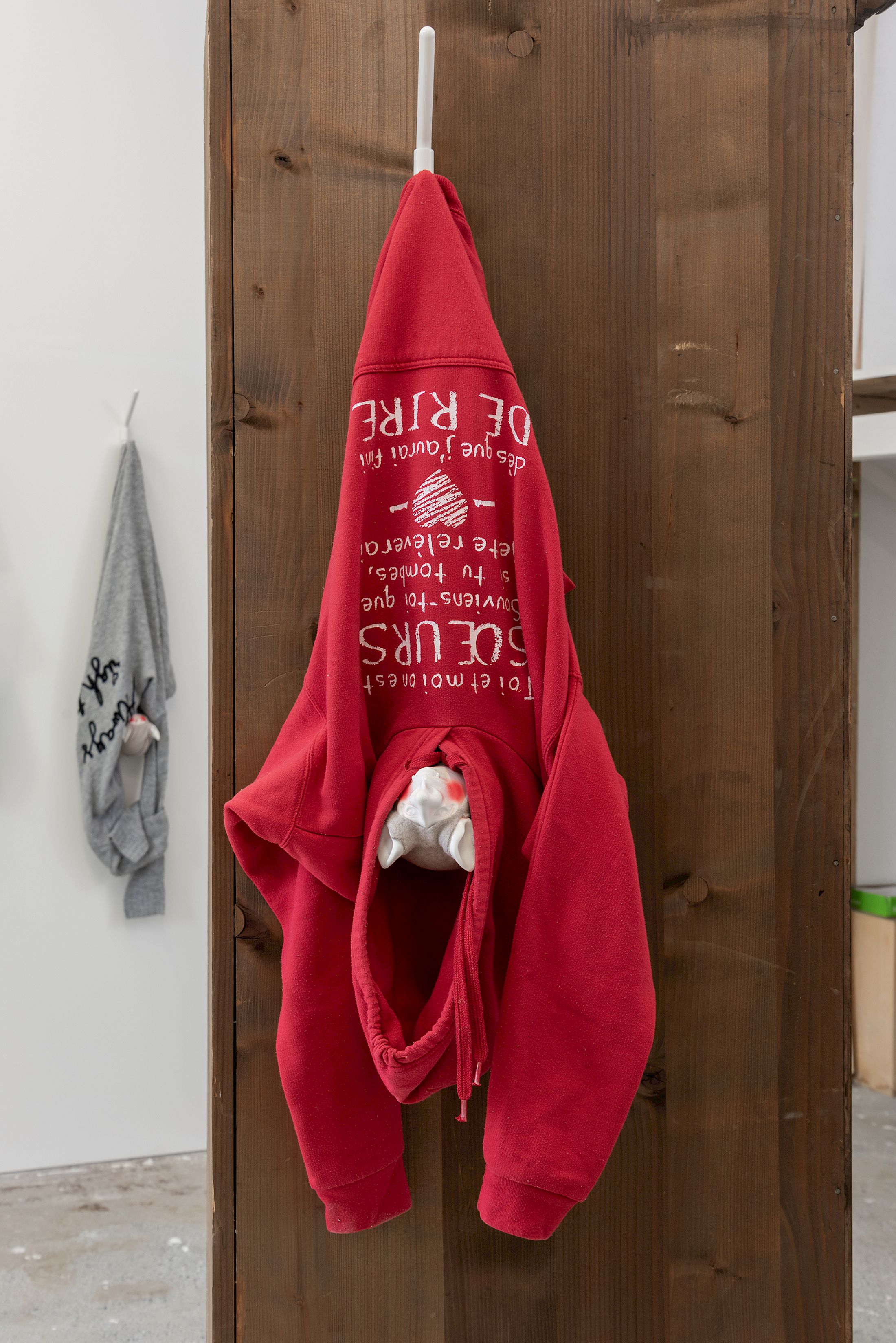 Exhibition View Group Show «Stocker comme des objets ; view on Virginie Sistek, ivre ensemble, 2026, T- shirt, coat rack, varnished Plasticrete acrylic resin, polystyrene, cotton fleece, wool, variable dimensions» at Widefield, Geneva, 2026 / Photo: Remy Ugarte Vallejos / Courtesy: the artists and Widefield