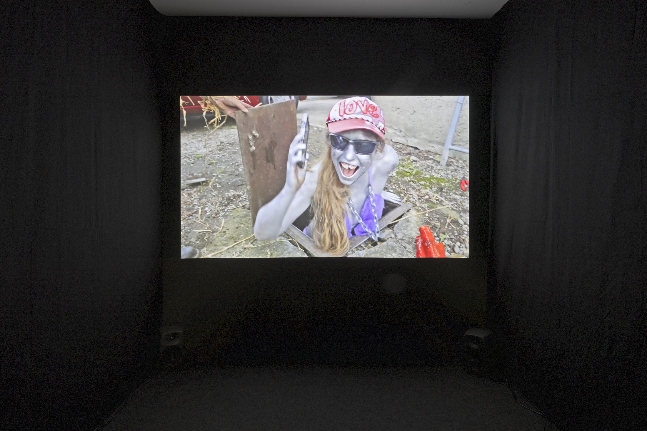 Exhibition View Group Show «Wear a mask and your face grows to fit it ; view on Leon Höllhumer, Parrot the Parent, 2023, short movie, 18 minutes» at For, Basel, 2025 / Photo: Gina Folly / Courtesy: the artists and For