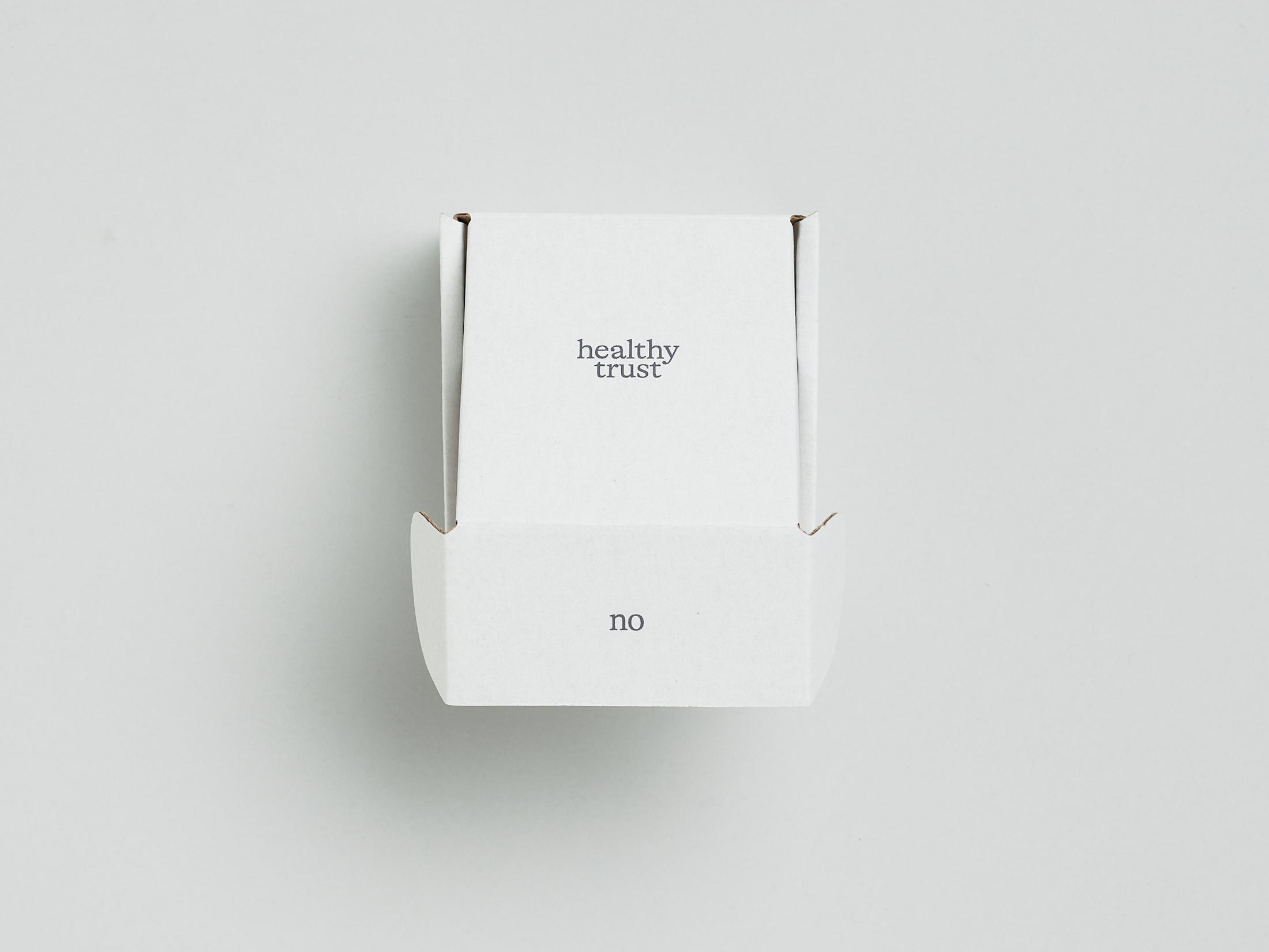 Exhibition View Solo Show Caroline Schattling Villeval «Carences et toute-puissance; view on Caroline  Schattling Villeval, No, no no healthy trust, 2023, A box containing a safety pin that joins together an object made of Murano glass and two or three silver-plated brass chains, wrapped in tissue paper (On the bottom of the box is printed a QR-code that gives access to the animation video, No, no no healthy trust, color, 2’, 2023), variable dimensions, black print on a white box, 9.2 x 9.2 x 5 cm» at Centre d'édition contemporaine, Geneva, 2024 / Photo: Sandra Pointet / Courtesy: the artist and Centre d'édition contemporaine, Geneva