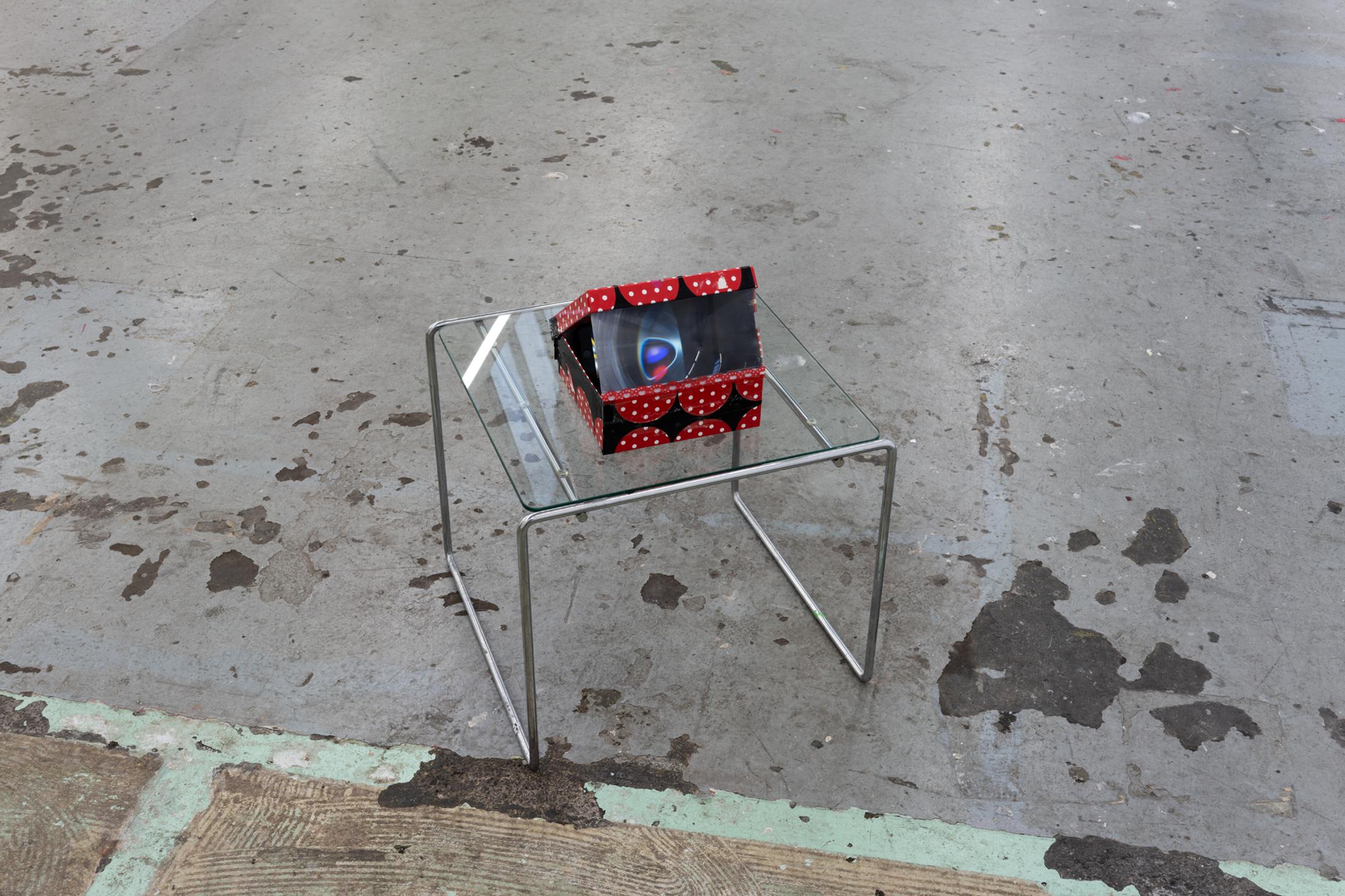 Exhibition View Duo Show «Image Volume ; view on Lorenza Longhi,  New Loop, 2024, Cardboard box, fresnel lens, adhesive tape, phone, video loop 17 x 19 x 21 cm» at Toxi, Zurich, 2024 / Photo: Thomas Julier / Courtesy: the artists and Toxi Space