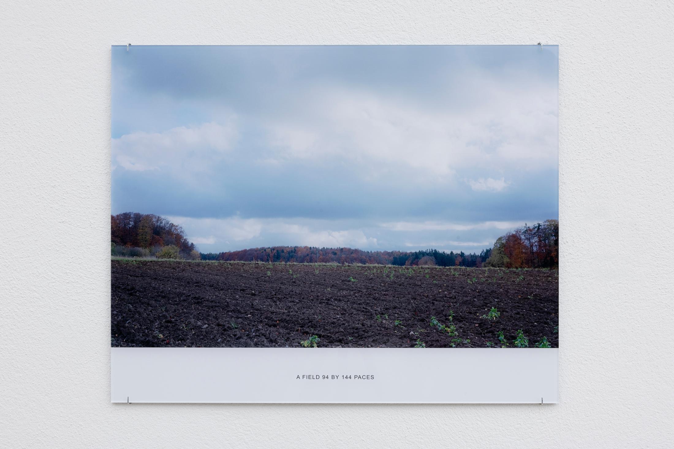 Exhibition View Solo Show Jay Chung & Q Takeki Maeda «GNOMONS 髀; view on Jay Chung & Q Takeki Maeda, A Field 94 by 144 Paces, 2023, C-print mounted to acrylic glass, 52 x 65 cm» at Kunsthaus Glarus, Glarus, 2024 / Photo: Gina Folly / Courtesy: the artists and Kunsthaus Glarus