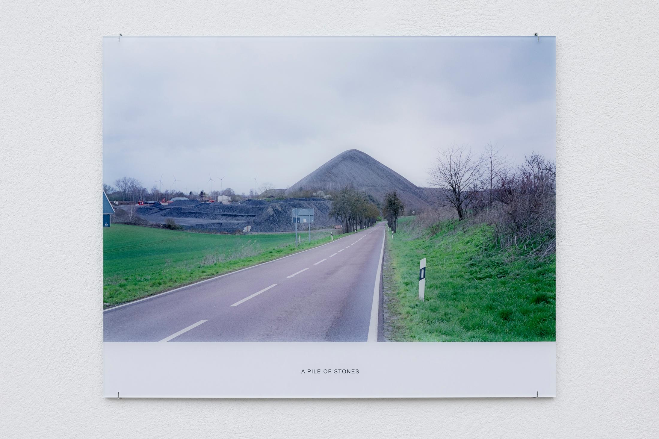Exhibition View Solo Show Jay Chung & Q Takeki Maeda «GNOMONS 髀; view on Jay Chung & Q Takeki Maeda, A Pile of Stones, 2023, C-print mounted to acrylic glass, 52 x 65 cm» at Kunsthaus Glarus, Glarus, 2024 / Photo: Gina Folly / Courtesy: the artists and Kunsthaus Glarus