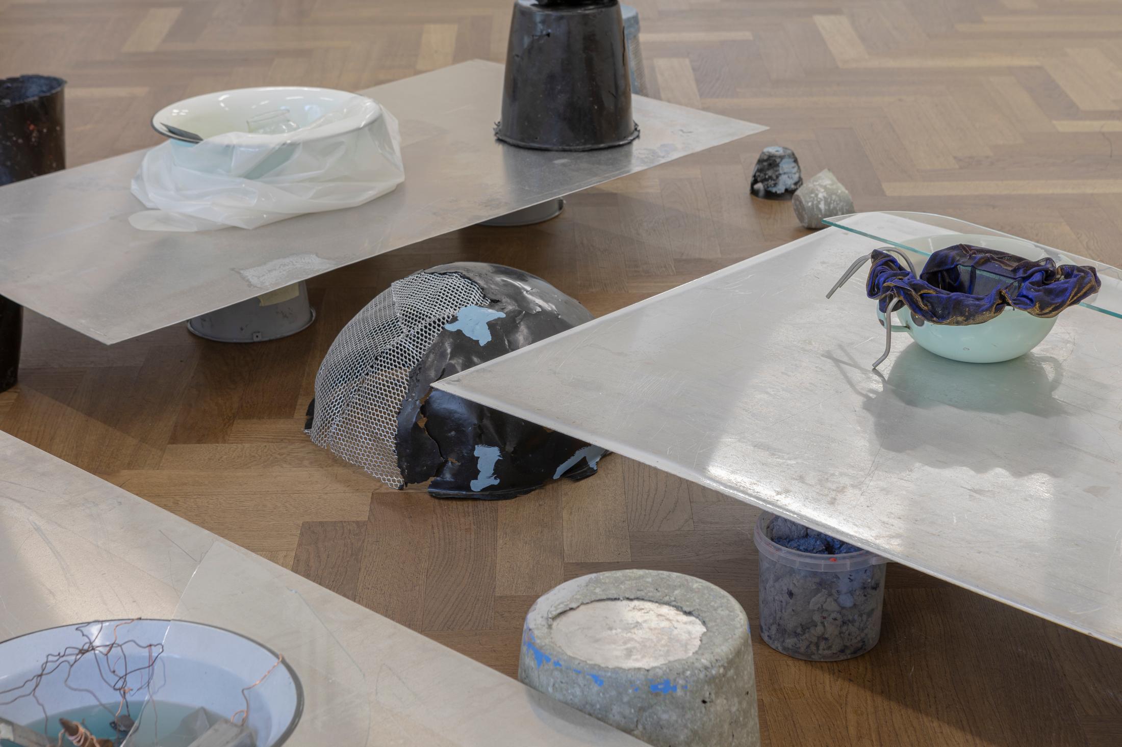 Exhibition View Solo Show Julia Znoj «BASS MY TRESPASS ; view on Setup (Direct Current) (detail), 2025, laboratory power supply, zinc electrolyte, water, paint, steel, aluminum, paper, glue, glass, wire, found objects, size variable» at Krone Couronne, Biel/Bienne, 2025 / Photo: Michal Schorro / Courtesy: the artist and Krone Couronne