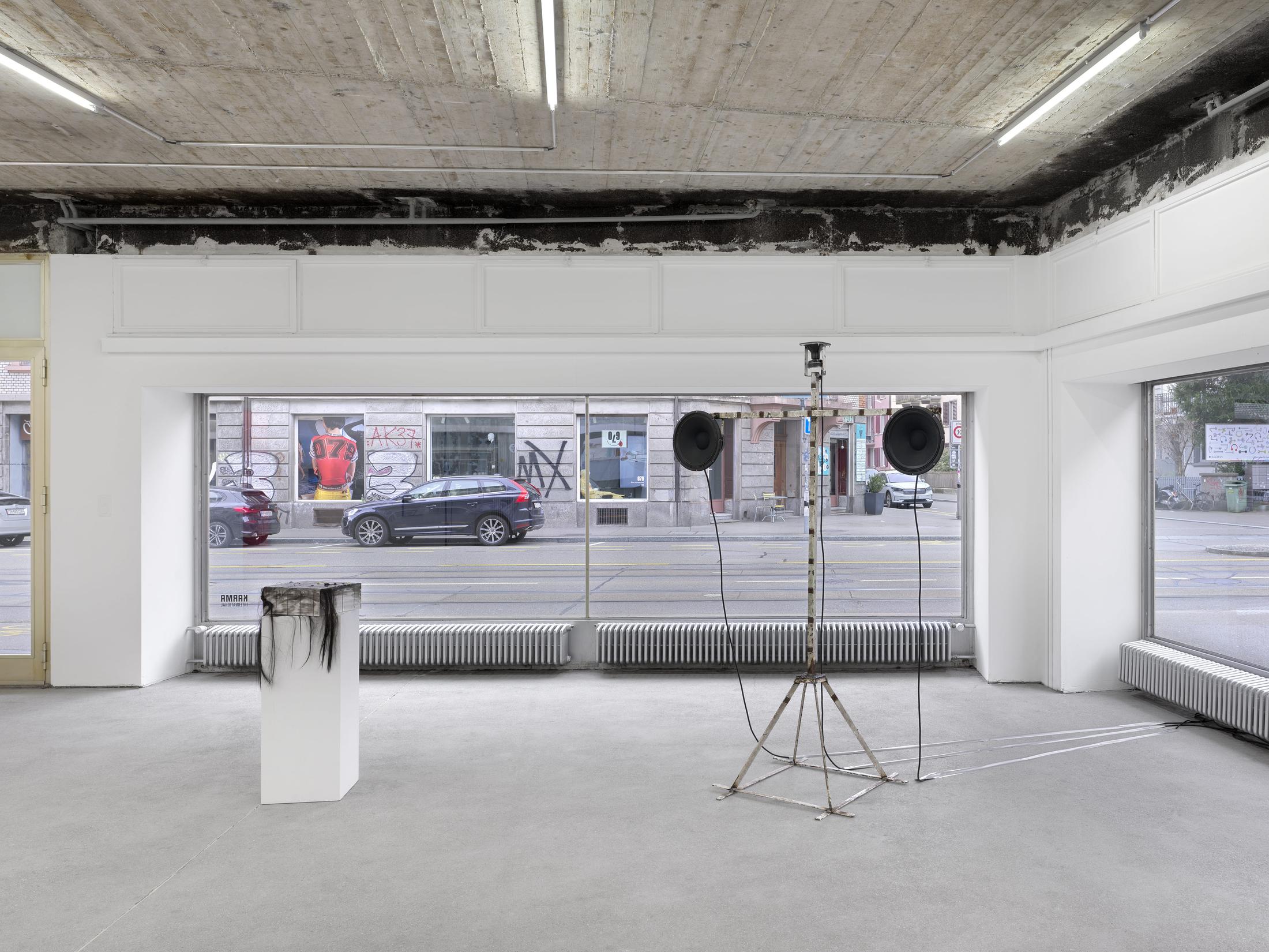Exhibition View Group Show with Leyla Faye, Sylvie Fleury, Pamela Rosenkranz, Markus Oehlen, Jasmine Gregory, Akeem Smith ; View on Akeem Smith , Twin Tower, 2024 , Salvaged building materials, speakers, audio,  212 x 152.5 x 71.5 cm  ; Jasmine Gregory , I don't want to be cremated. I want my body to be stuffed like Chanel's first bag, 2025 , palette with oil, rhinestones, acrylic, hair exten- sions and glitter on amina muaddi box , 12 x 28 x 30 cm , at Karma International, Zürich, 2025 / Photo: Annik Wetter / Courtesy : the artists and Karma International