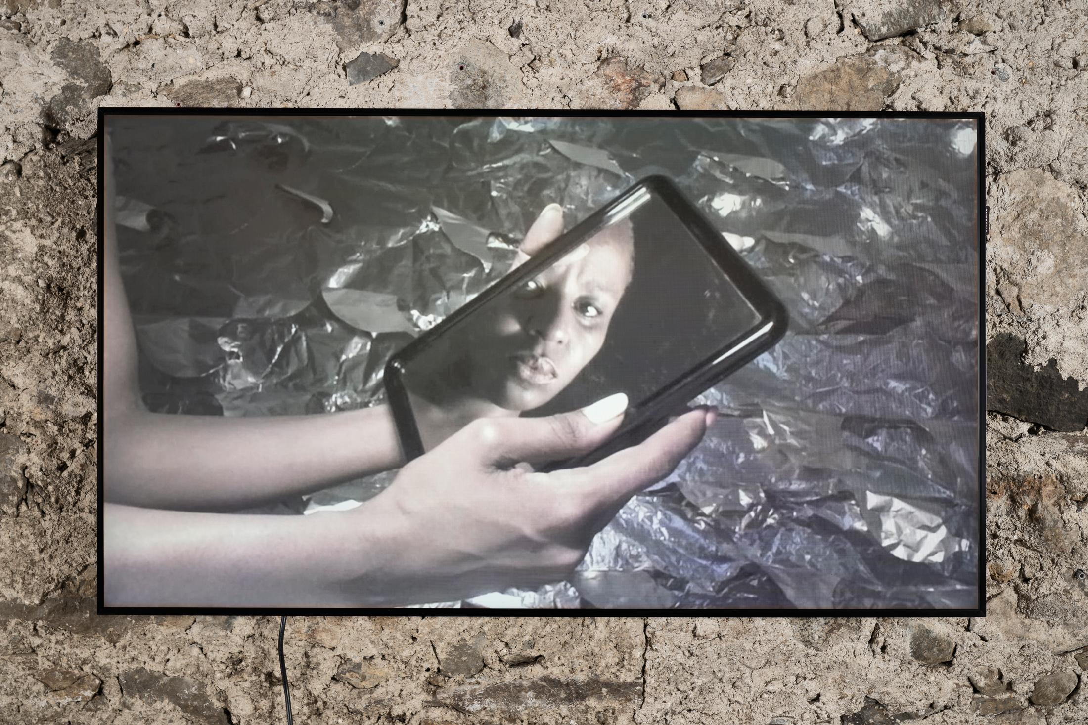 Exhibition View donna Kukama Solo Show «transcendence; view on donna Kukama, Chapter H: Yesterday, the cries of our mirror-reflections sang-songs, 2020, Video, Film Still, duration 05 min 02 sec» at Galerie Tschudi, Zuoz, 2023 / Photo: Ralph Feiner / Courtesy: the artist and Galerie Tschudi