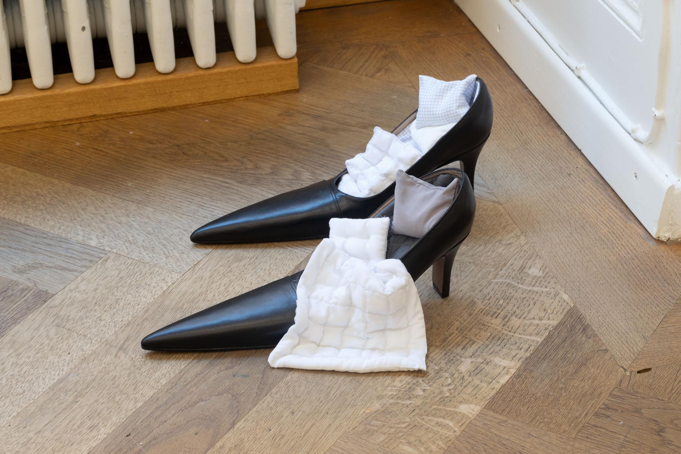 Exhibition View Leolie Greet with Amélie Bodenmann, Anina Müller and Nina Rieben Show «mumbles slide along the sleeve; view on Nina Rieben, Sidelines in a corner of potentiel, 2023, modified heel shoes, textile objects» at Krone Couronne, Biel, 2023 / Photo: Guadalupe Ruiz / Courtesy: the artist and Krone Couronne