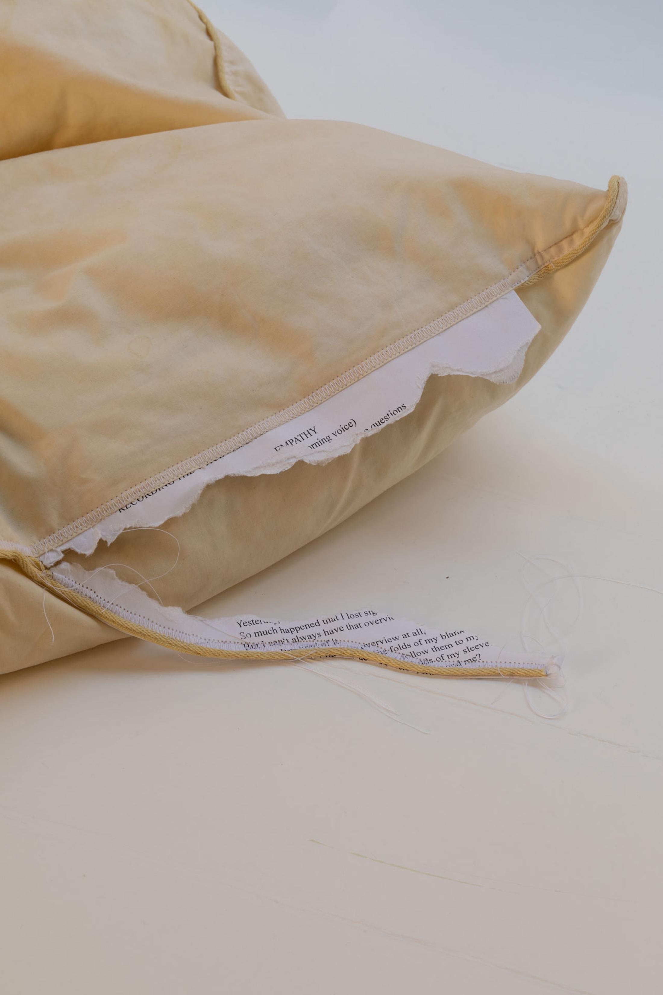 Exhibition View Leolie Greet with Amélie Bodenmann, Anina Müller and Nina Rieben Show «mumbles slide along the sleeve; view on Anina Müller & Leolie Greet, btw this is a message from Empathy, 2023, audio, iphone, cushion, stitched paper» at Krone Couronne, Biel, 2023 / Photo: Guadalupe Ruiz / Courtesy: the artists and Krone Couronne