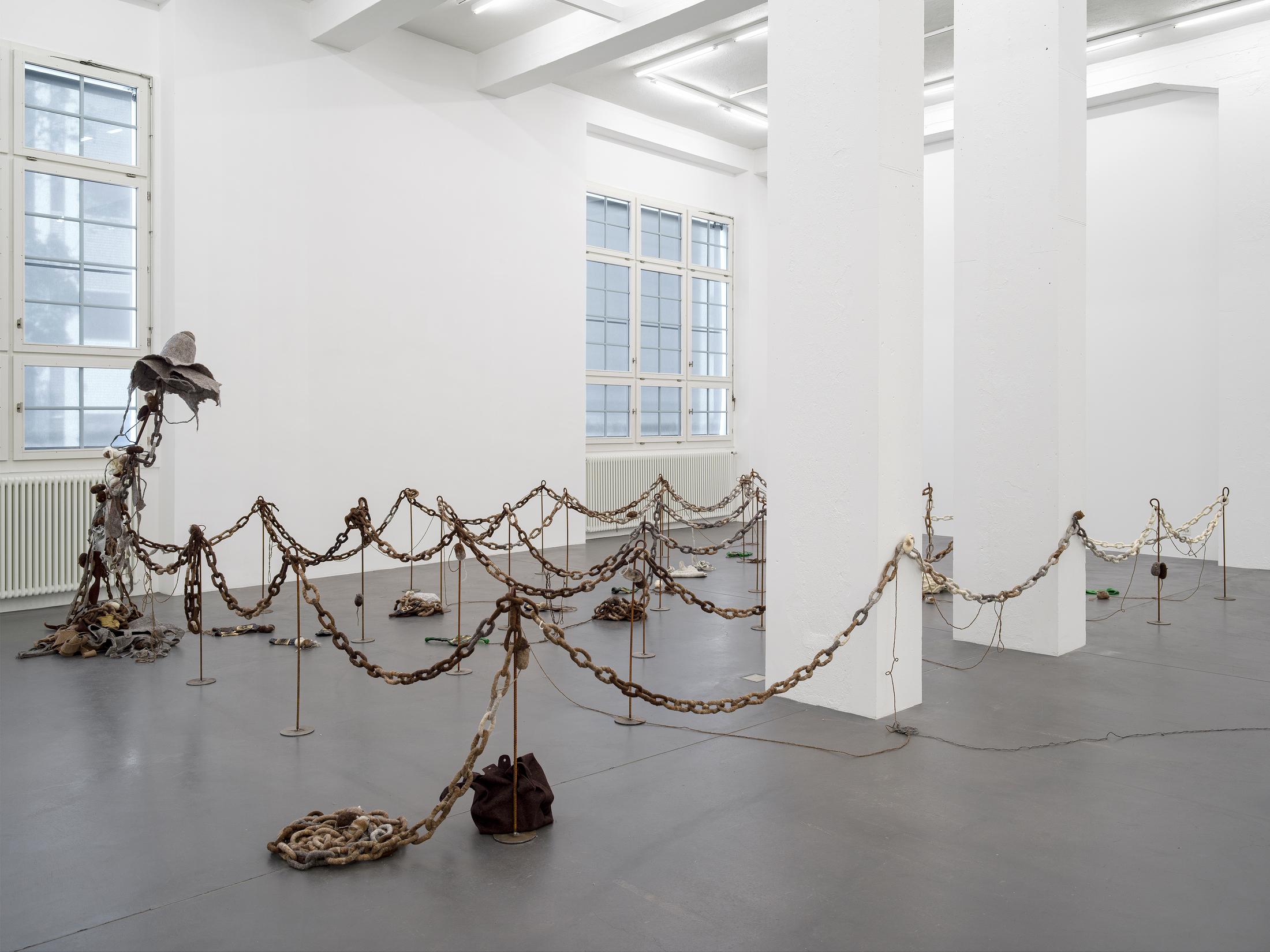 Exhibition View Solo Show Min Yoon «Perspectives + ing; view on Min Yoon, Digest + ing + Wait + ing Time to Emit, 2024, Wool felt, recycled glass bottles, steel, Dimensions variable» at Galerie Francesca Pia, Zurich, 2024 / Photo: Cedric Mussano / Courtesy: The artist and Galerie Francesca Pia