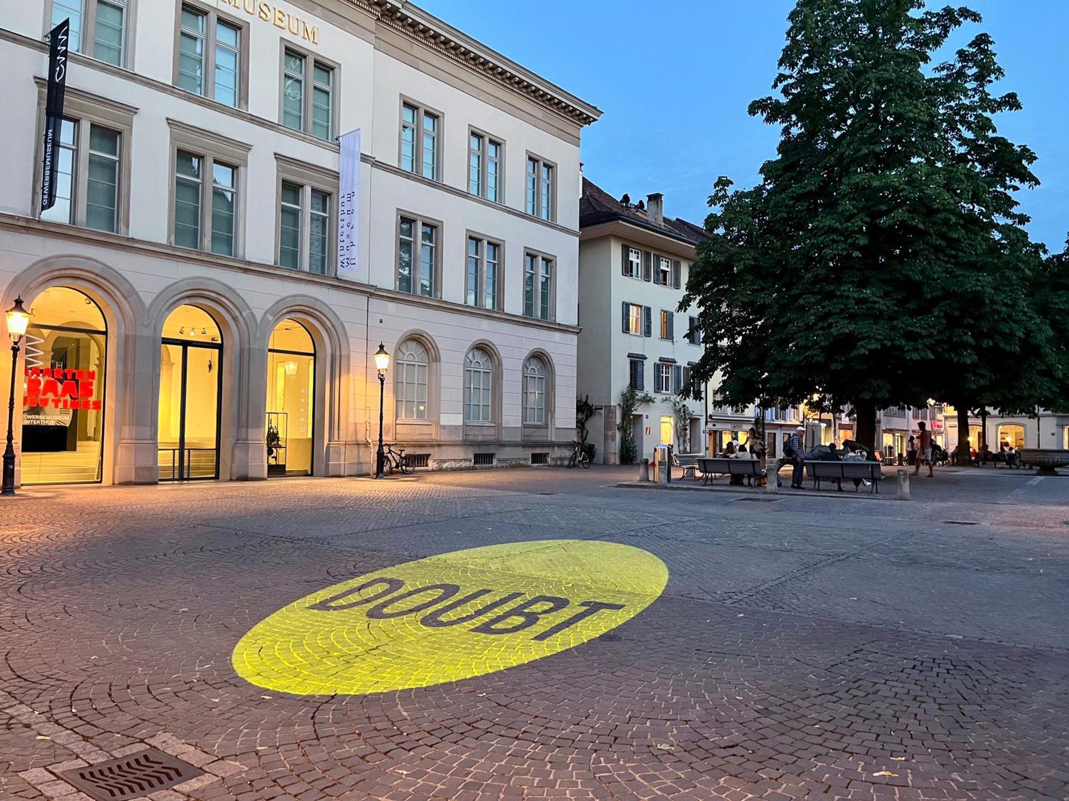 Exhibition View Solo Show Nancy Dwyer «Hot Mess ; view on Shadow of A Doubt 2, 2024, light projection, dimensions variable, on the square behind Kunsthalle at nightfall» at Kunsthalle Winterthur, 2024 / Photo: Cedric Mussano / Courtesy: the artist, and Theta, New York