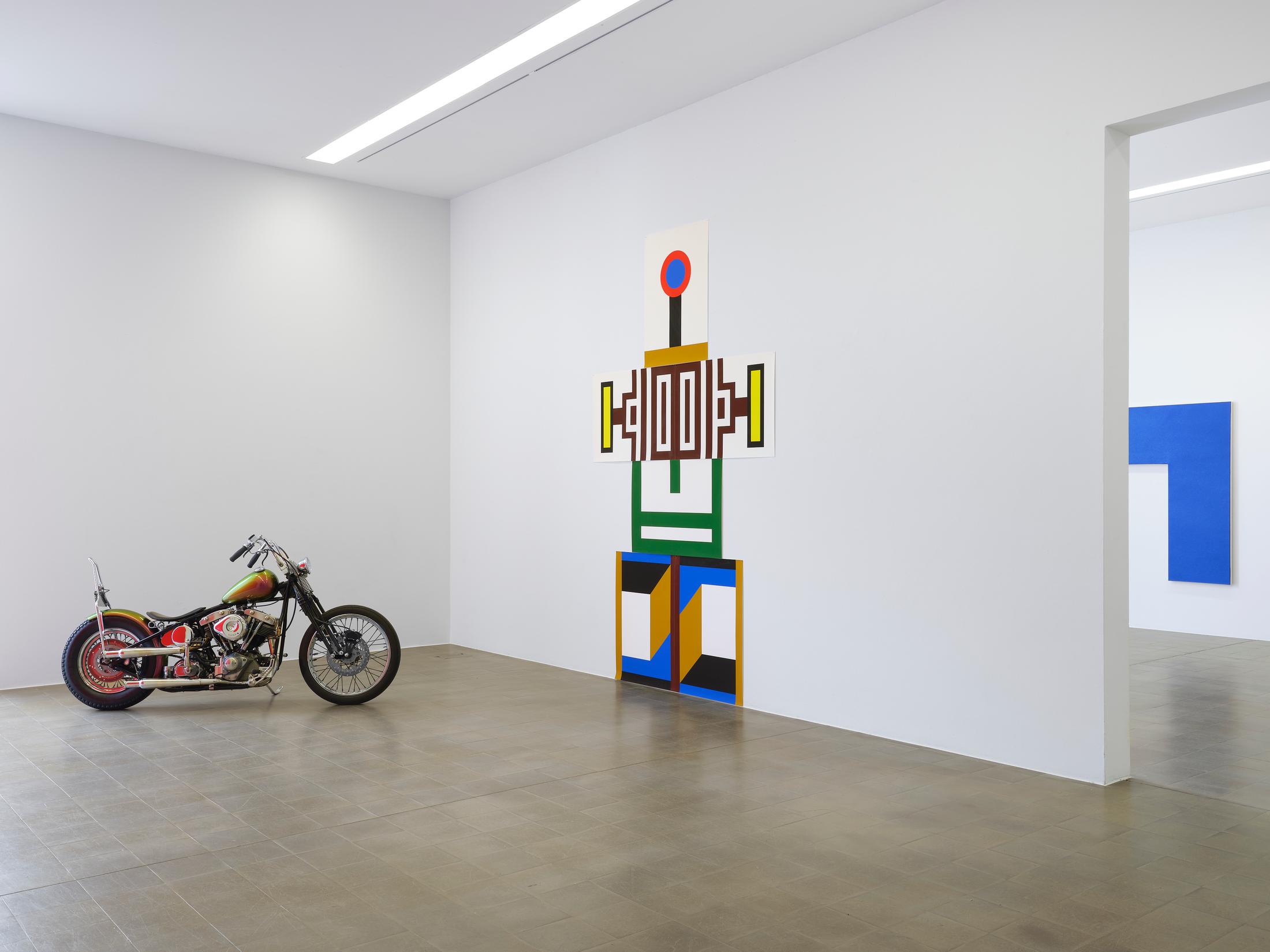 Exhibition View Duo Show Nathalie Du Pasquier and Olivier Mosset «1+1 = 3 ; view on Olivier Mosset, Sans titre, 2024, Harley Davidson modele Shovel FLH 80 (court. SYMETRIA), and Nathalie Du Pasquier, Sans titre, 2024, impressions sur papier» at Kunsthaus Biel / Centre d'Art Bienne, Biel/Bienne, 2024 / Photo: Thomas Annaheim Lambert / Courtesy: the artists and Kunsthaus Biel
