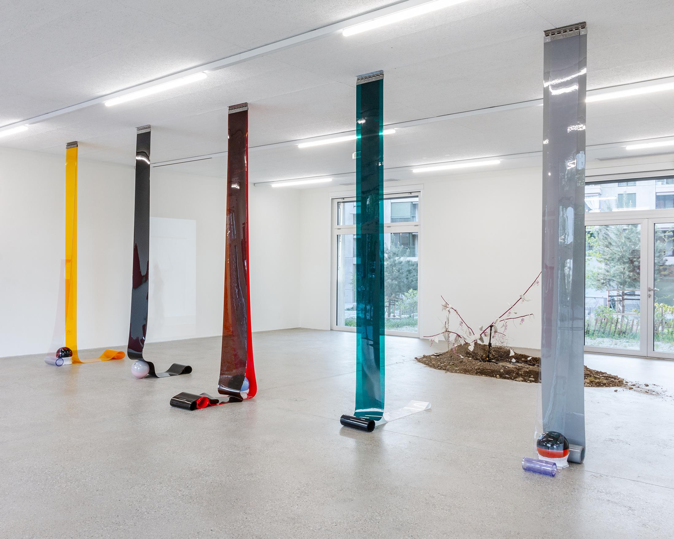 Exhibition View Group Show «Our Labor, Our Passion, Our Love; view on Charly Mirambeau, Private Pursuits and Public Problems, 2024, stainless steel rail, PVC, glass, fabric (five elements)» at CALM - Centre d'Art la Meute, Lausanne, 2024 / Photo: Théo Dufloo / Courtesy: The artist and CALM - Centre d'Art La Meute