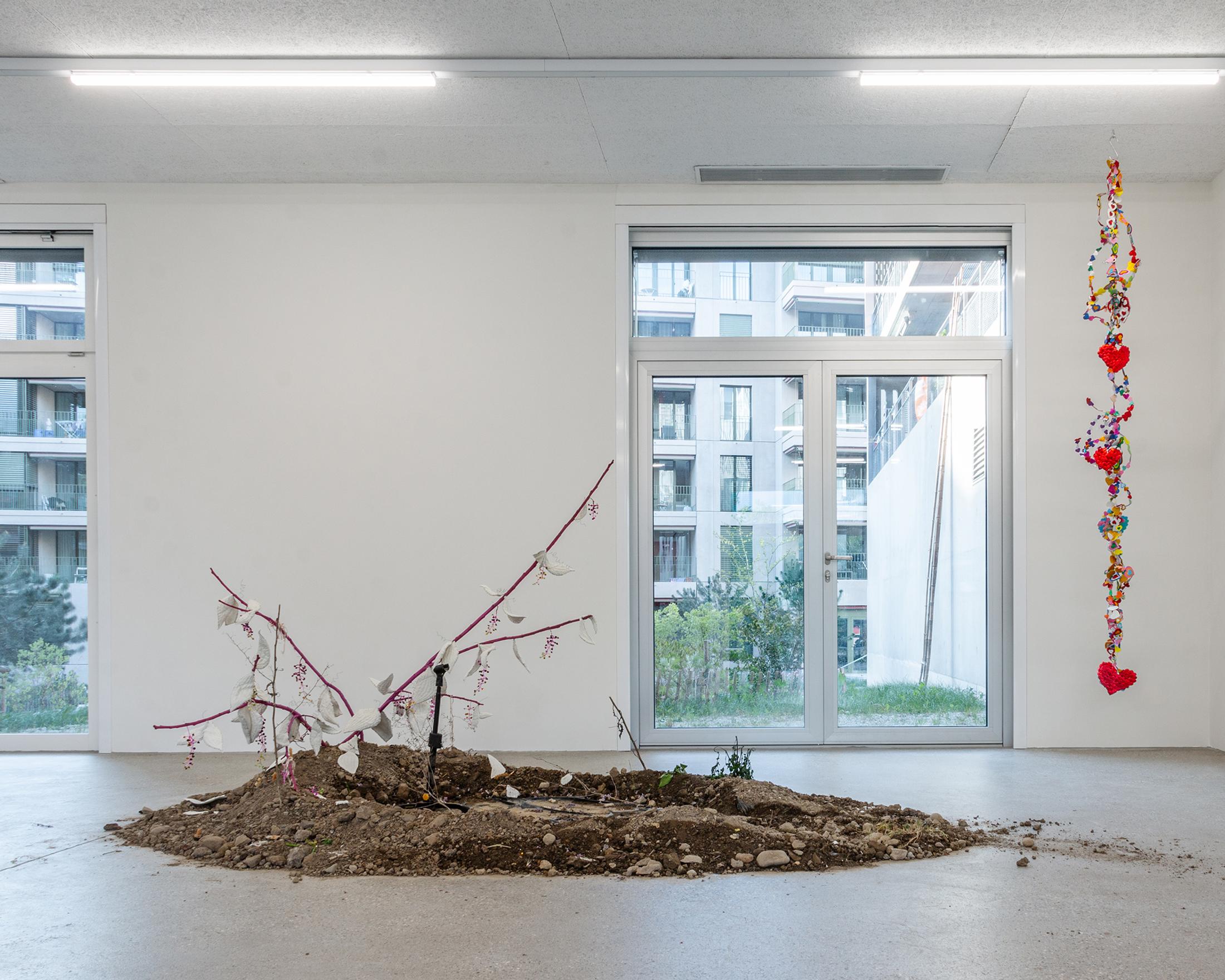 Exhibition View Group Show «Our Labor, Our Passion, Our Love; view on Juri Bizzotto, Phytolacca Vol. 1, 2024, installation and performance, branches, beads, fabric, microphone, dim. variable» at CALM - Centre d'Art la Meute, Lausanne, 2024 / Photo: Théo Dufloo / Courtesy: The artist and CALM - Centre d'Art La Meute