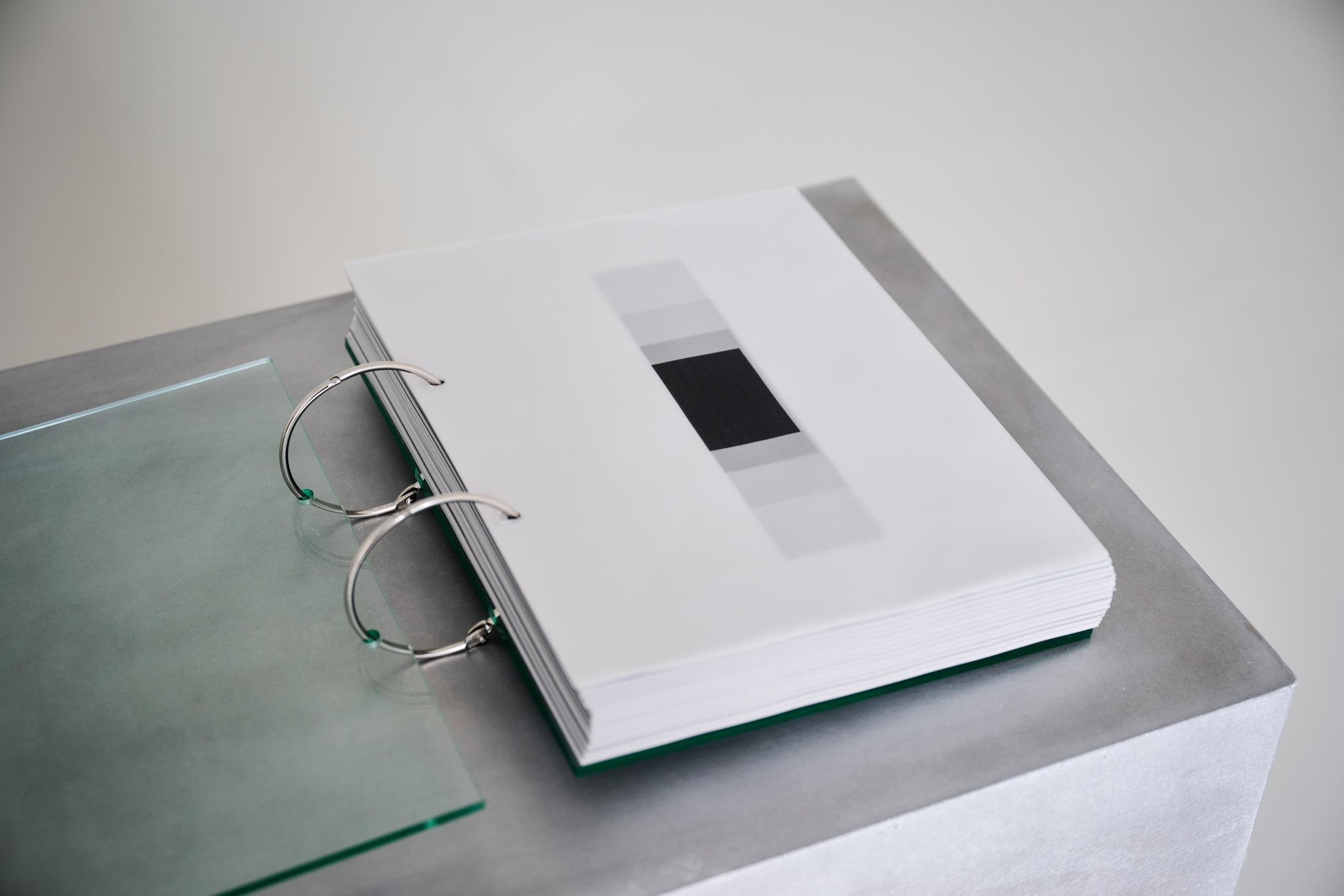 Exhibition View Solo Show Pauline Cordier «Holding Time; view on Pauline Cordier, 366, glass, printed on tracing paper, brushed aluminium, edition : 25 × 20 × 4 cm, base : 100 × 55 × 35 cm, 2024» at andata ritorno - laboratoire d'art contemporain, Geneva, 2024 / Photo: Loïc Herin / Courtesy: The artist and andata ritorno - laboratoire d'art contemporain