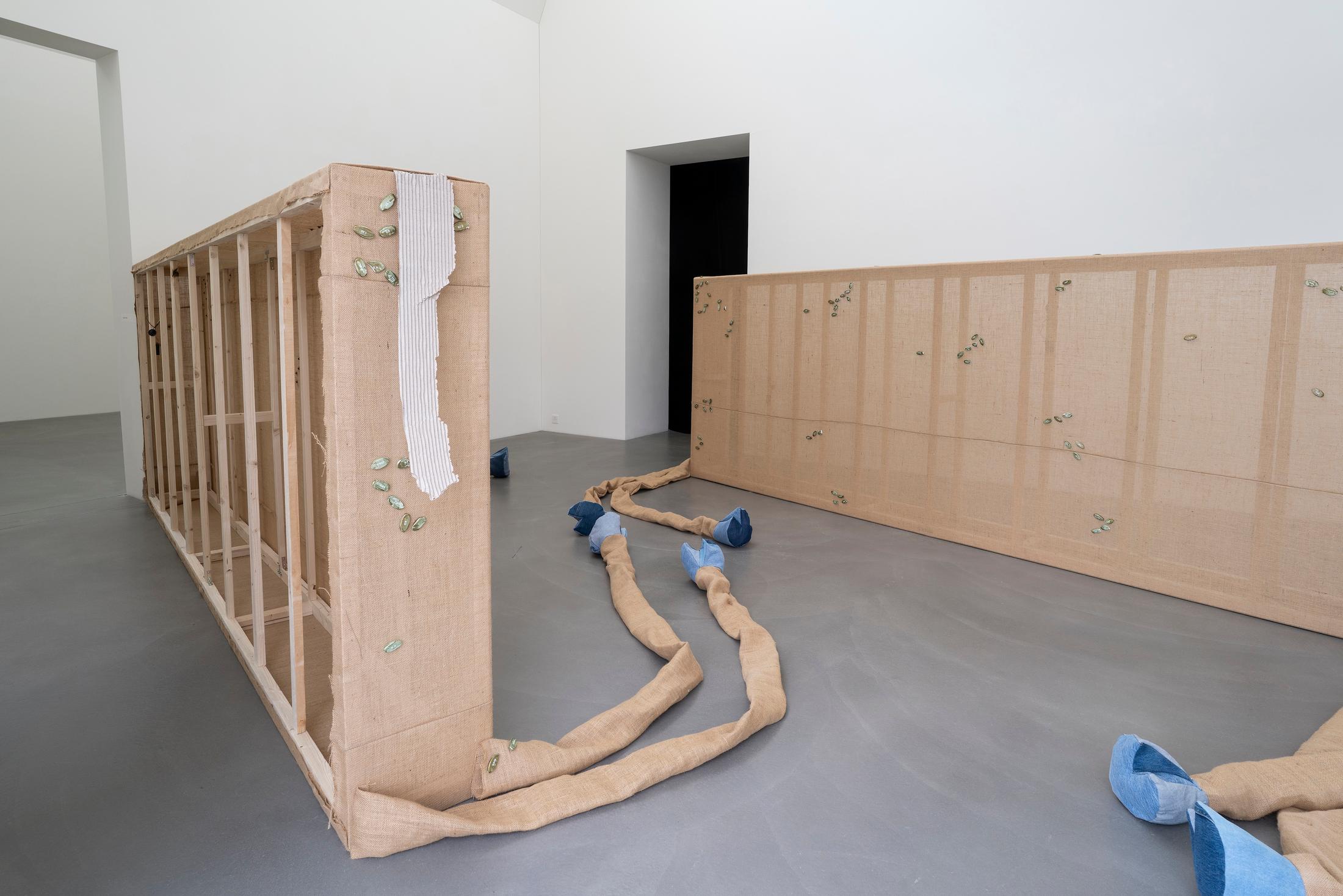 Exhibition View Group Show «Plattform24; view on Virginie Sistek, Resurrection Ranch, 2024, Wood, burlap flap, jeans, wadding, plaster, paint, transfer sticker, butterfly clasp brooch, MP3 sound chip module, paper, 660 x 574 cm» at Kunstmuseum Kunsthalle Appenzell, Appenzell, 2024 / Photo: Claude Barrault / Courtesy: The artists and Kunstmuseum Kunsthalle Appenzell