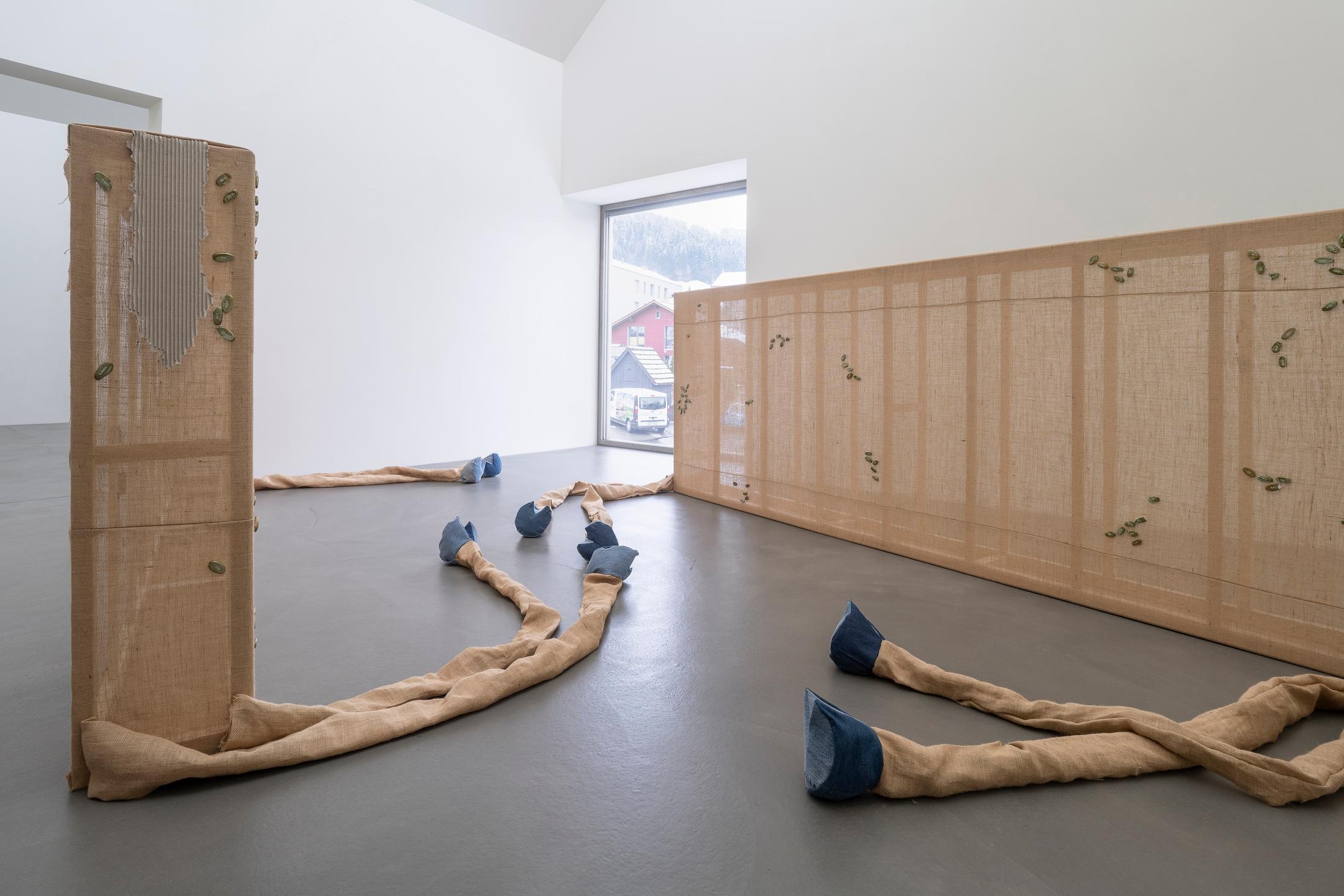 Exhibition View Group Show «Plattform24; view on Virginie Sistek, Resurrection Ranch, 2024, Wood, burlap flap, jeans, wadding, plaster, paint, transfer sticker, butterfly clasp brooch, MP3 sound chip module, paper, 660 x 574 cm» at Kunstmuseum Kunsthalle Appenzell, Appenzell, 2024 / Photo: Claude Barrault / Courtesy: The artists and Kunstmuseum Kunsthalle Appenzell