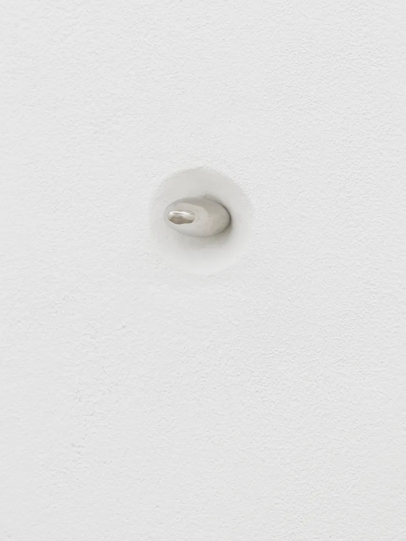 Exhibition View Solo Show Sanna Helena Berger «Nicht-nur-Spekulativ; view on Sanna Helena Berger, Gegengewicht für Schwerpunktthema (Eine Frage der Möglichkeit, die Kommodifizierung der Konditionen der Sammelbarkeit zu ästhetisieren), 2024, Sterling silver 925 almond 0.5 x 0.8 x 2.5 cm» at Galerie PHILIPPZOLLINGER, Zurich, 2024 / Photo: Conradin Frei / Courtesy: The artist and Galerie PHILIPPZOLLINGER