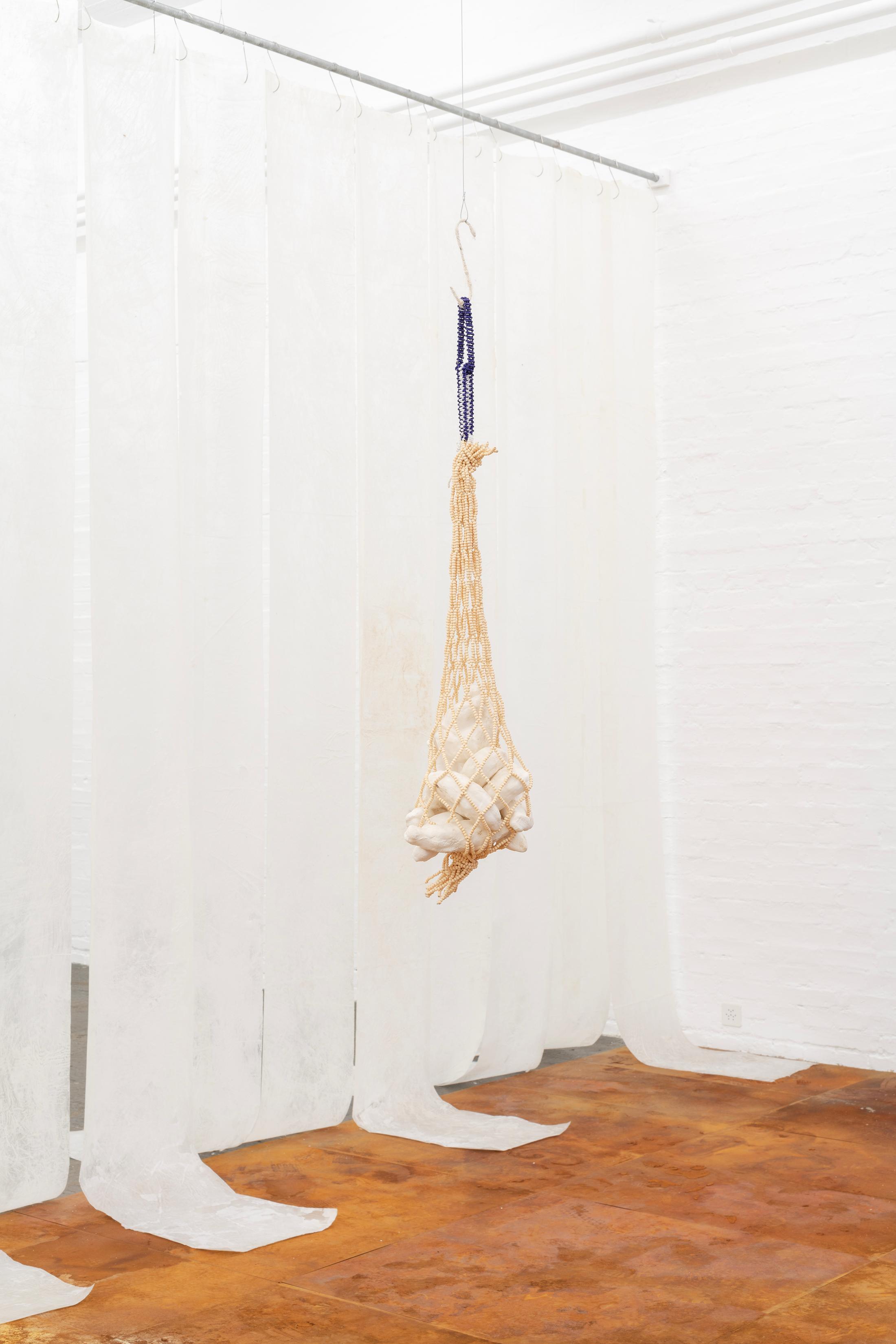 Exhibition View Double Show Sofía Salazar Rosales «Imagínate vivir en Suiza y perderte esto ; view on They asked to stay, 2025, Wood beads, glass beads, wire thread, plaster bandages, paraffin,
110 x 20 x 20 cm» at Kunst Halle Sankt Gallen, St. Gallen, 2025 / Photo: E. Sommer / Courtesy: the artist and ChertLüdde, Berlin