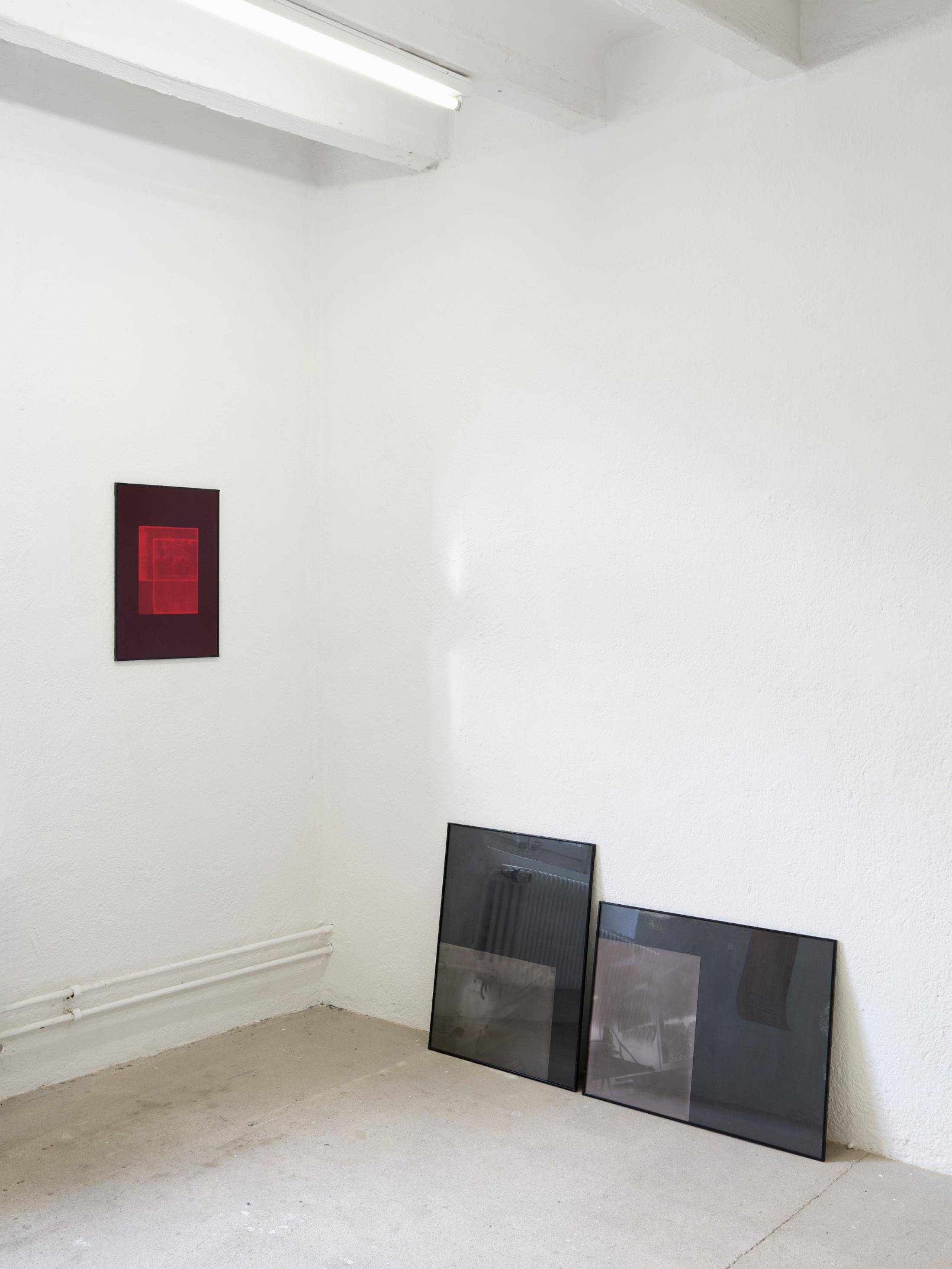 Exhibition View Group Show «The House, the Paste, the Weather (part 1); view on Lorenzo de Bellis, Durchschauend (hand with torch), b/w photo on overdeveloped glass, 2024 ; Durchschauend (window), b/w photo on overdeveloped photo-glass, 2024 ; In the red, b/w unfixed photograph, red plexiglass, 2024» at Stiftung Binz39, Zurich, 2024-2025 / Photo: Conradin Frei / Courtesy: the artists and Stiftung Binz39