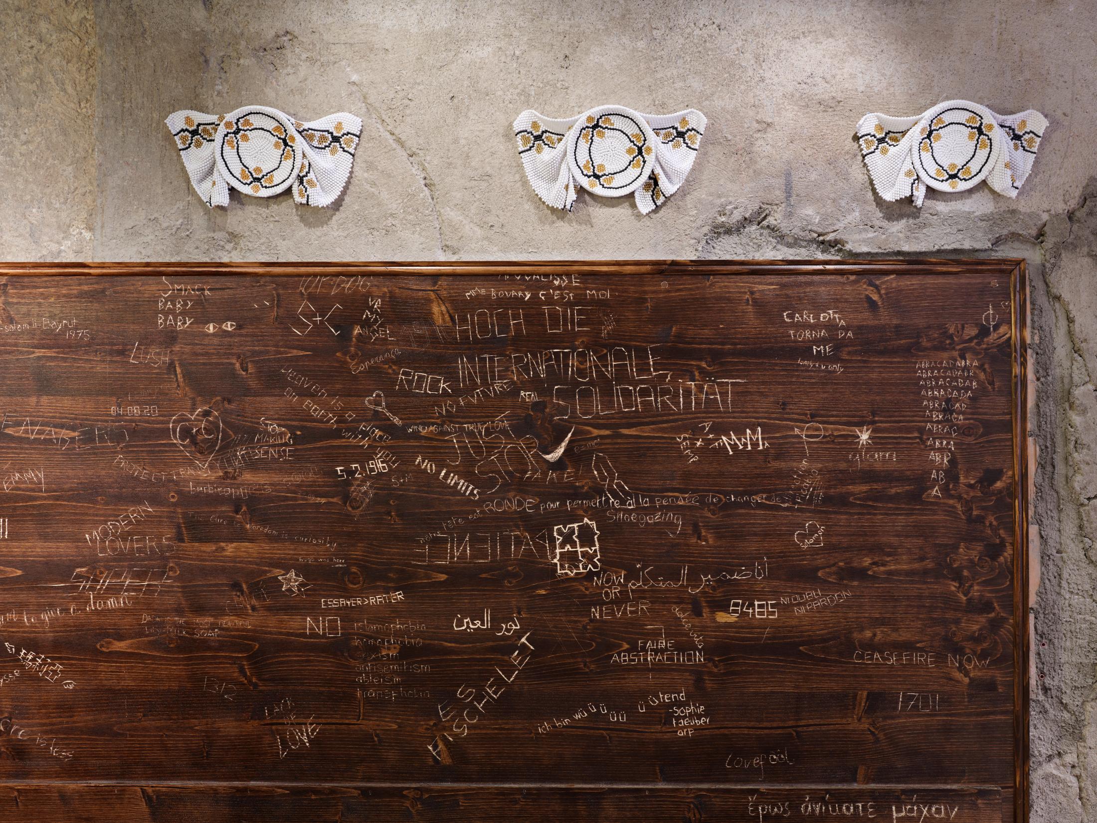 Exhibition View Group Show «The Red Herring; view on Laura Nan, Granny Isn’t Dead, Granny’s just transforming, 2024 and Collective work, Bathroom poetry (detail), 2024» at Cabaret Voltaire Artists’ Bar, Zurich, 2025 / Photo: Philipp Hänger / Courtesy: the artists and Cabaret Voltaire