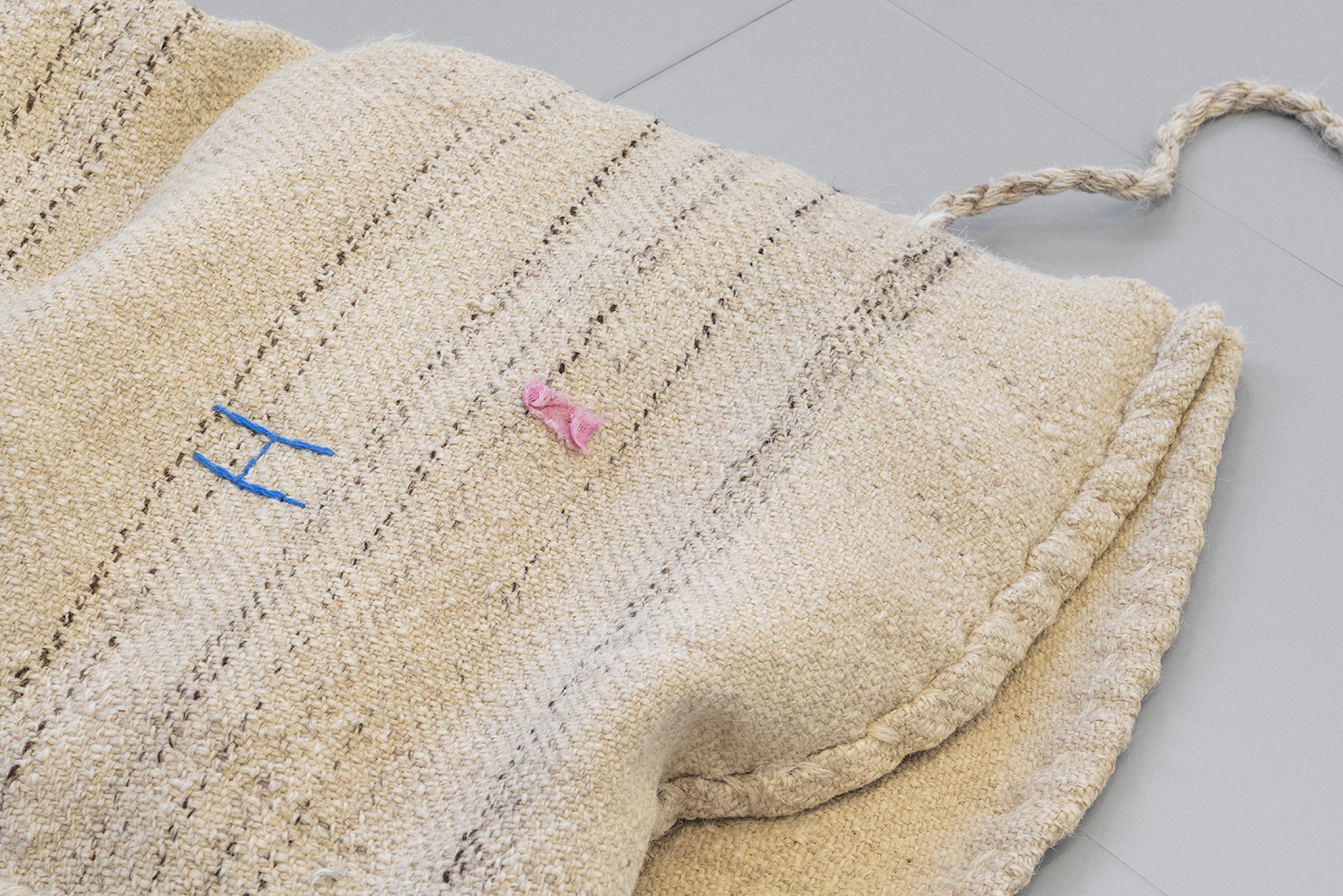 Exhibition View Group Show «Unseen Reconstructions; view on Vladimir Miljević, Transboundary Waters (Fruits of Labour), 2023, coastal wool bags with walnuts and metallic buoys» at La Rada, Locarno, 2023 / Photo: Riccardo Giancola / Courtesy: the artist and La Rada