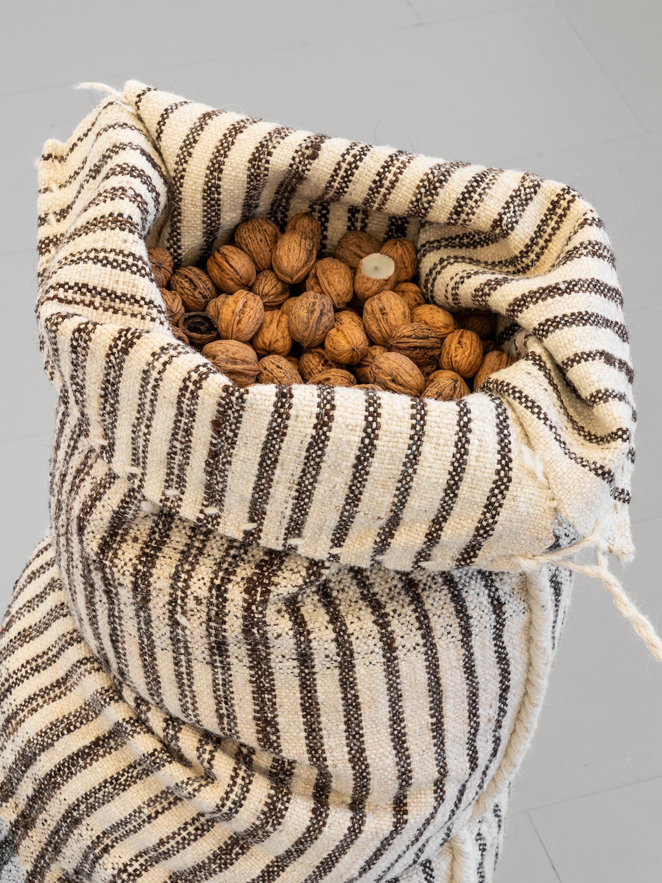 Exhibition View Group Show «Unseen Reconstructions; view on Vladimir Miljević, Transboundary Waters (Fruits of Labour), 2023, coastal wool bags with walnuts and metallic buoys» at La Rada, Locarno, 2023 / Photo: Riccardo Giancola / Courtesy: the artist and La Rada