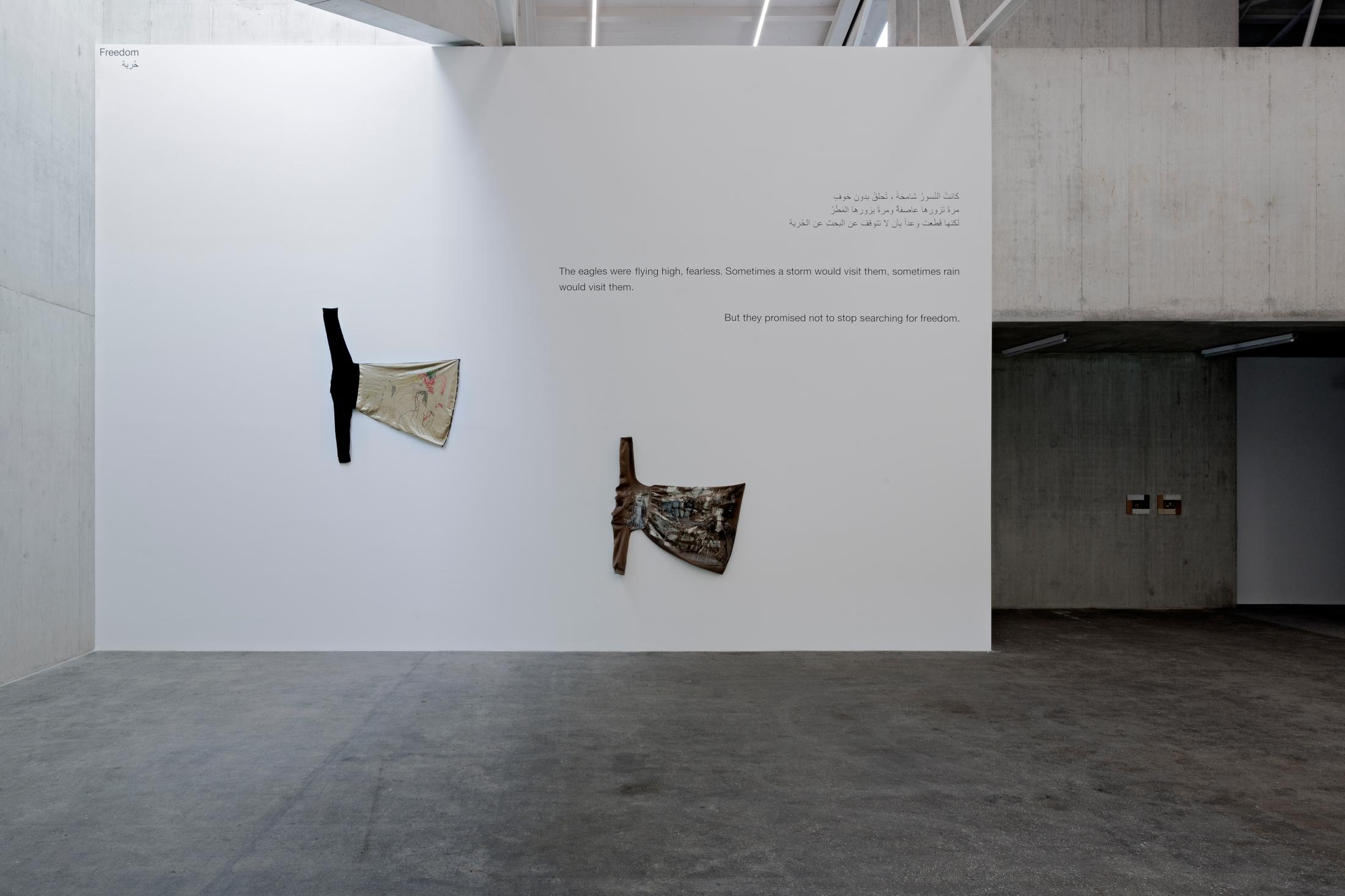 Exhibition View Group Show «In Between Between No More and Not Yet; view on ysha E Arar, Guernica, 2023, Acryl on dress 205 x 138 cm, Goose in love, 2023, ballpoint pen on dress, 33 x 160 cm» at Kunsthaus Baselland, 2024 / Photo: Gina Folly / Courtesy: the artist and Kunsthaus Baselland