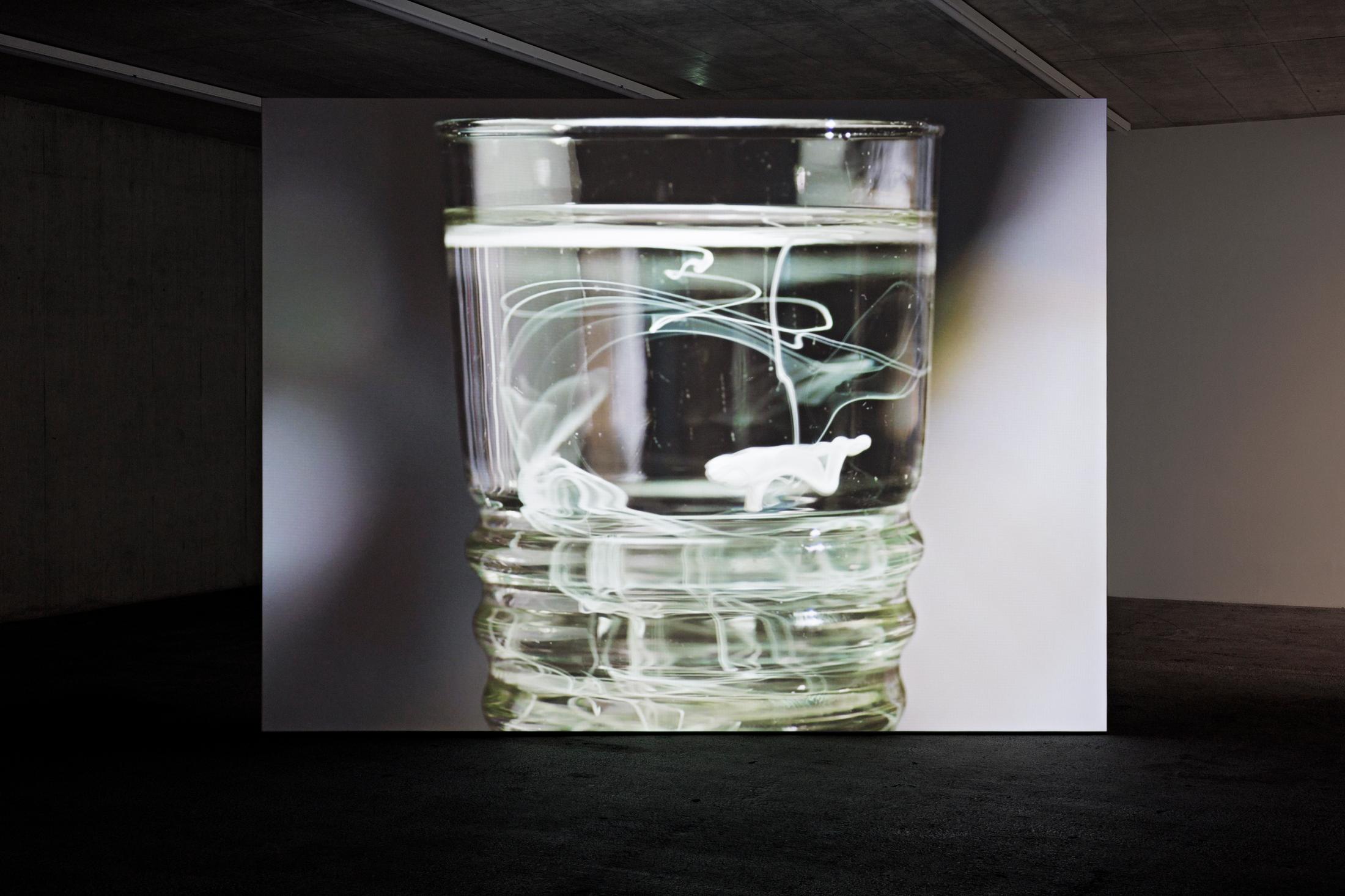 Exhibition View Group Show «In Between Between No More and Not Yet; view on Marijke Van Warmerdam, Dream machine, 2006 35 mm Film Loop, Color 2’39” Projector, Loop-System» at Kunsthaus Baselland, 2024 / Photo: Gina Folly / Courtesy: the artist and Kunsthaus Baselland